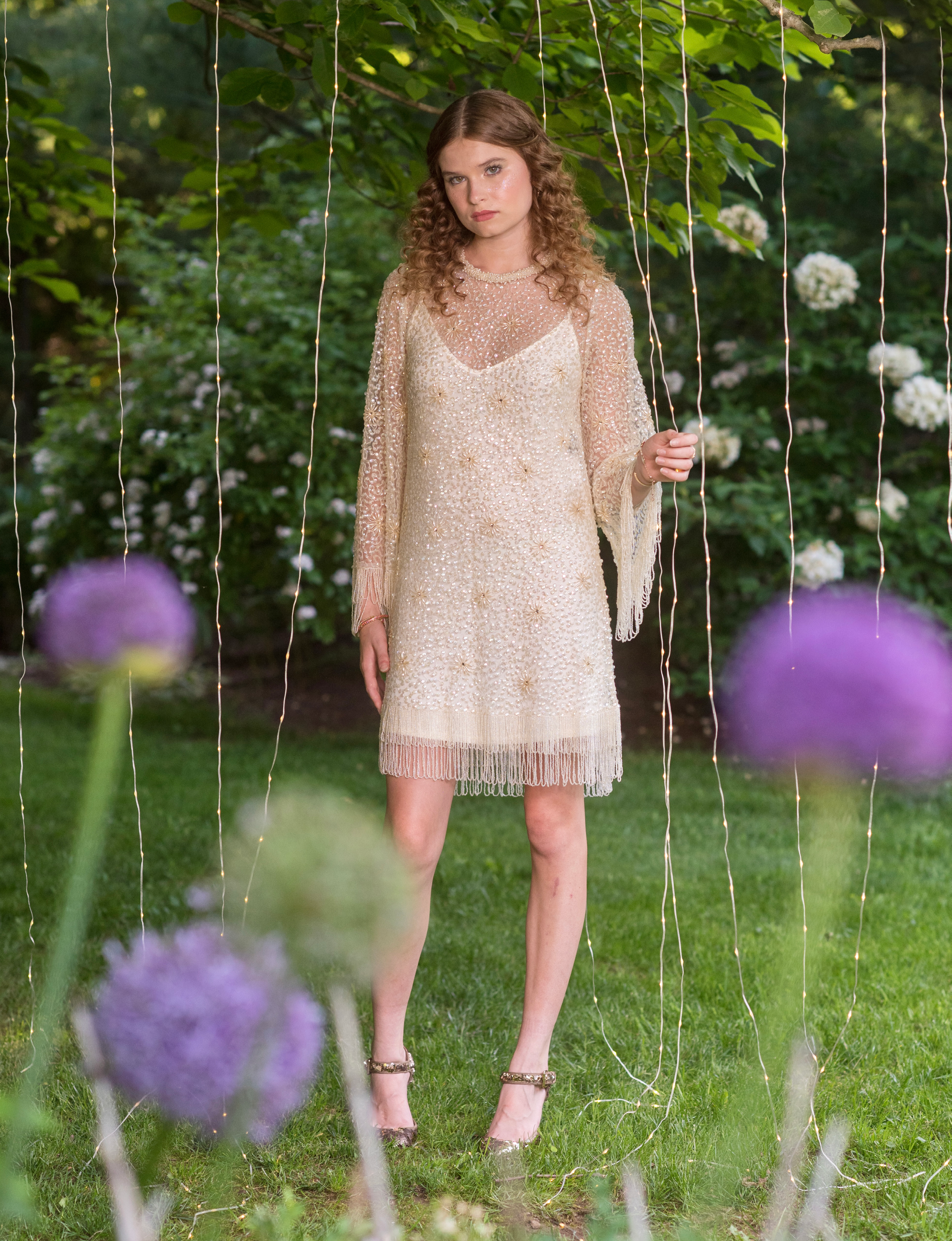 model Samantha Lee posing in garden in summer