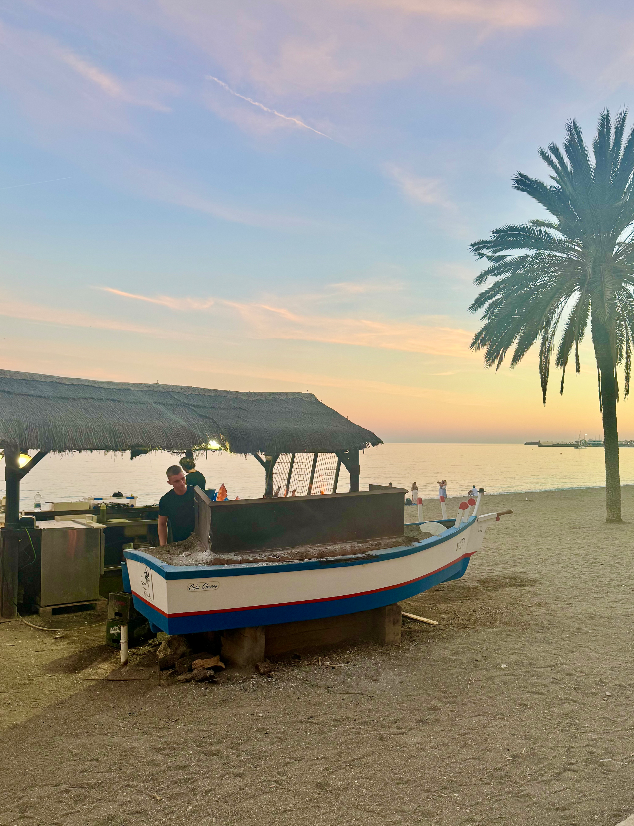 eating on the beach at sunset in Malaga Spain
