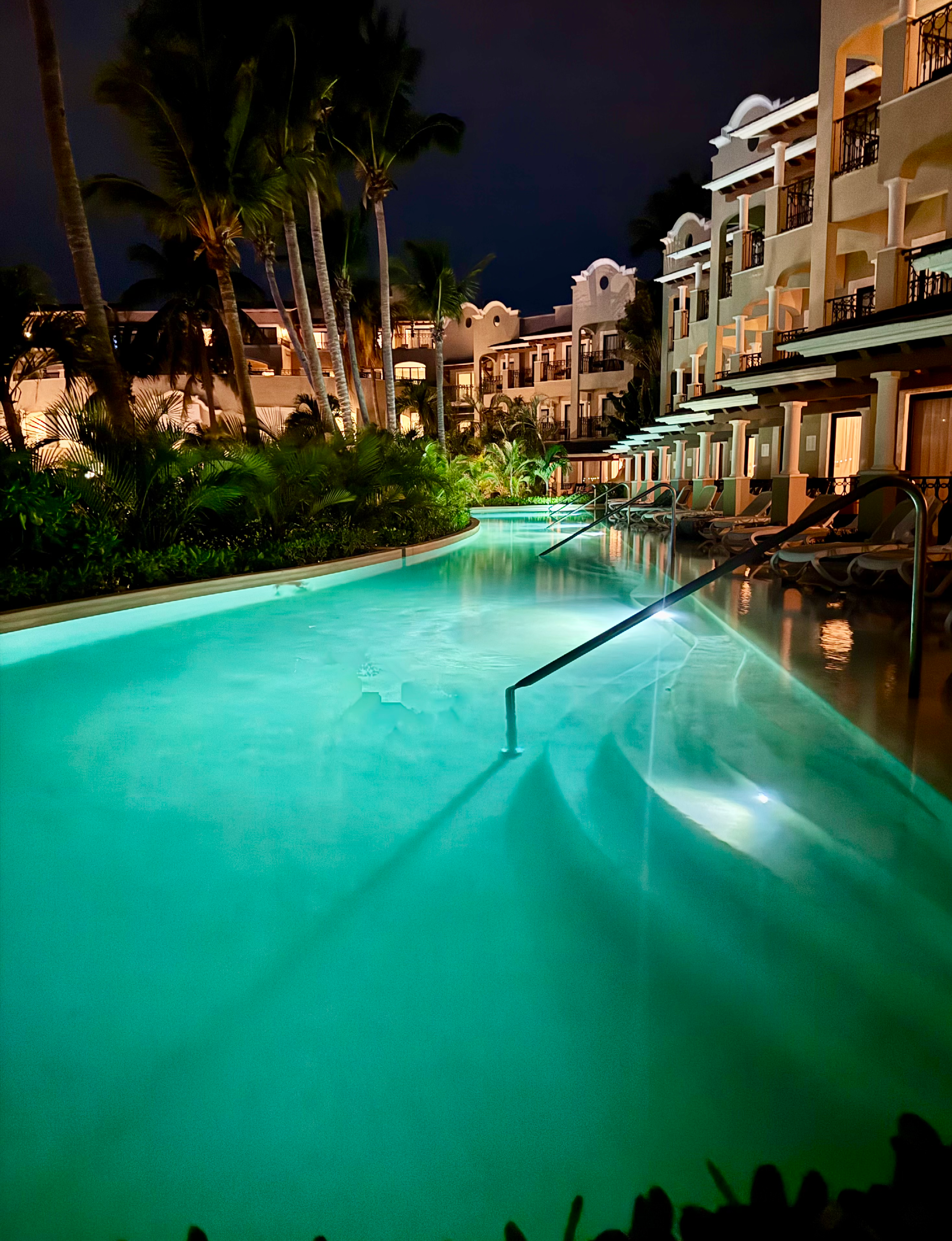 the illuminated swim-out pool at the adults-only Hyatt Zilara Riviera Maya resort in Mexico at night
