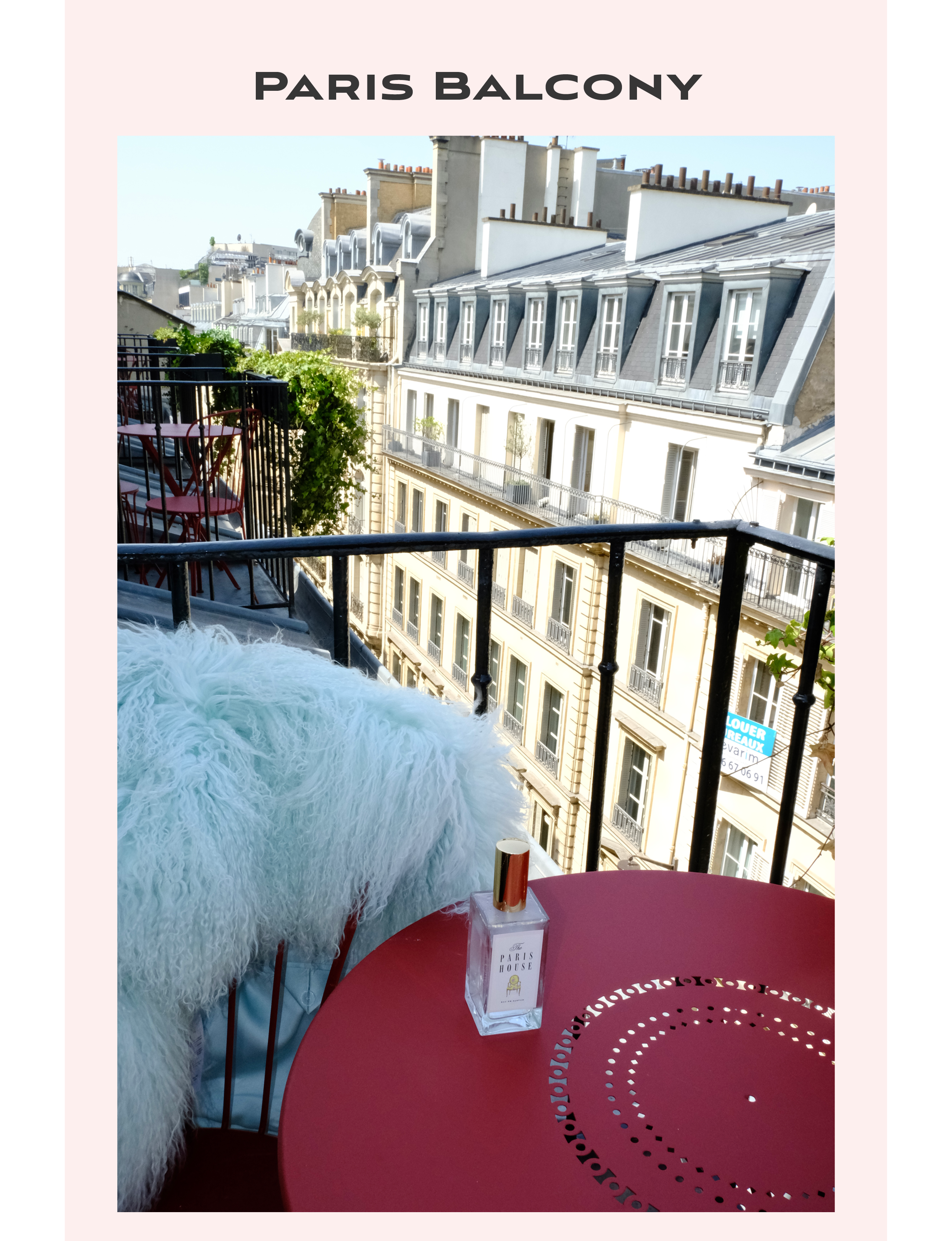 Parisian balcony view featuring a classic round red metal bistro table and a soft light blue textured throw and a delicate Paris House Beauty perfume bottle