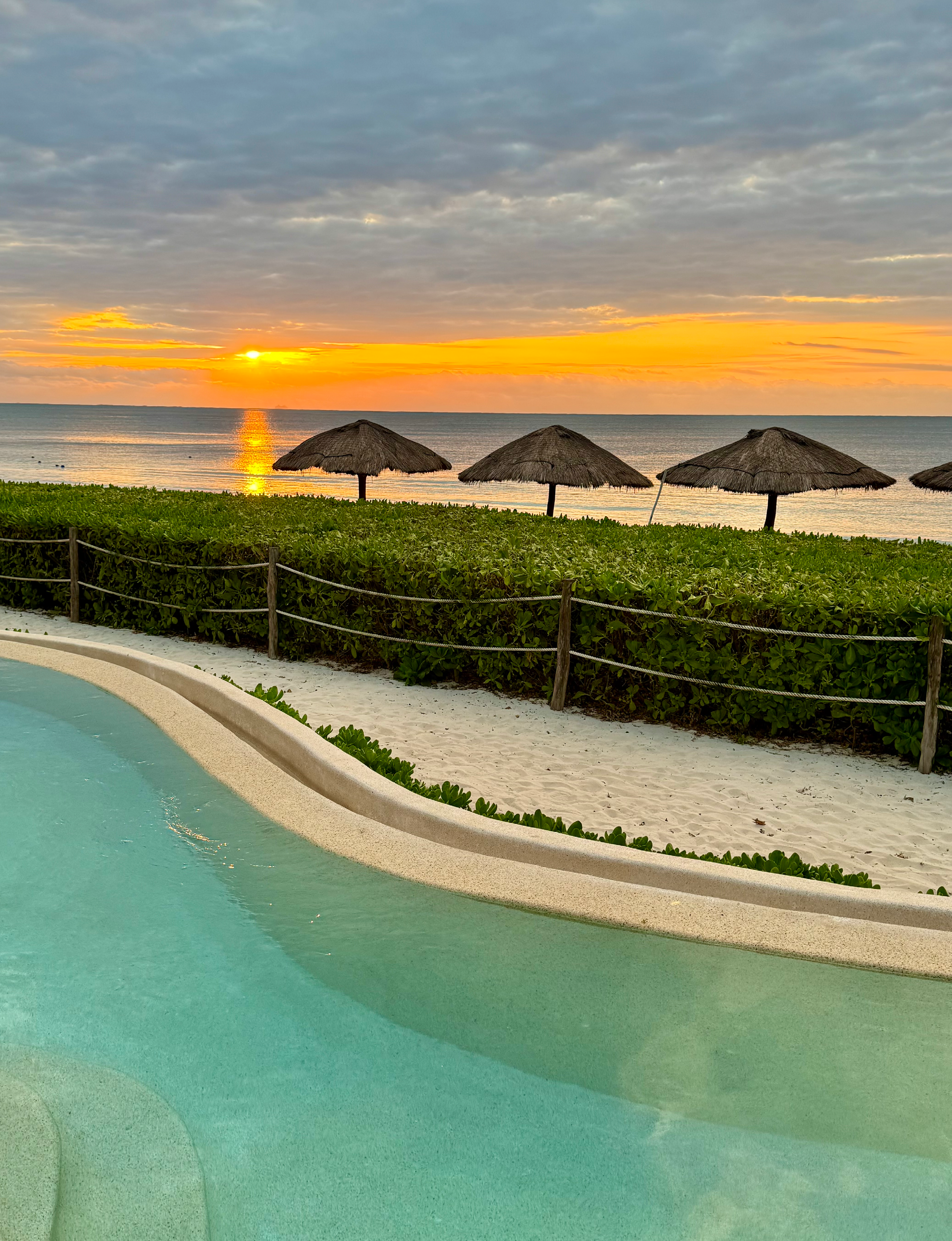 scenic sunrise view overlooks the Caribbean Sea from the oceanfront pool area at Hyatt in Mexico