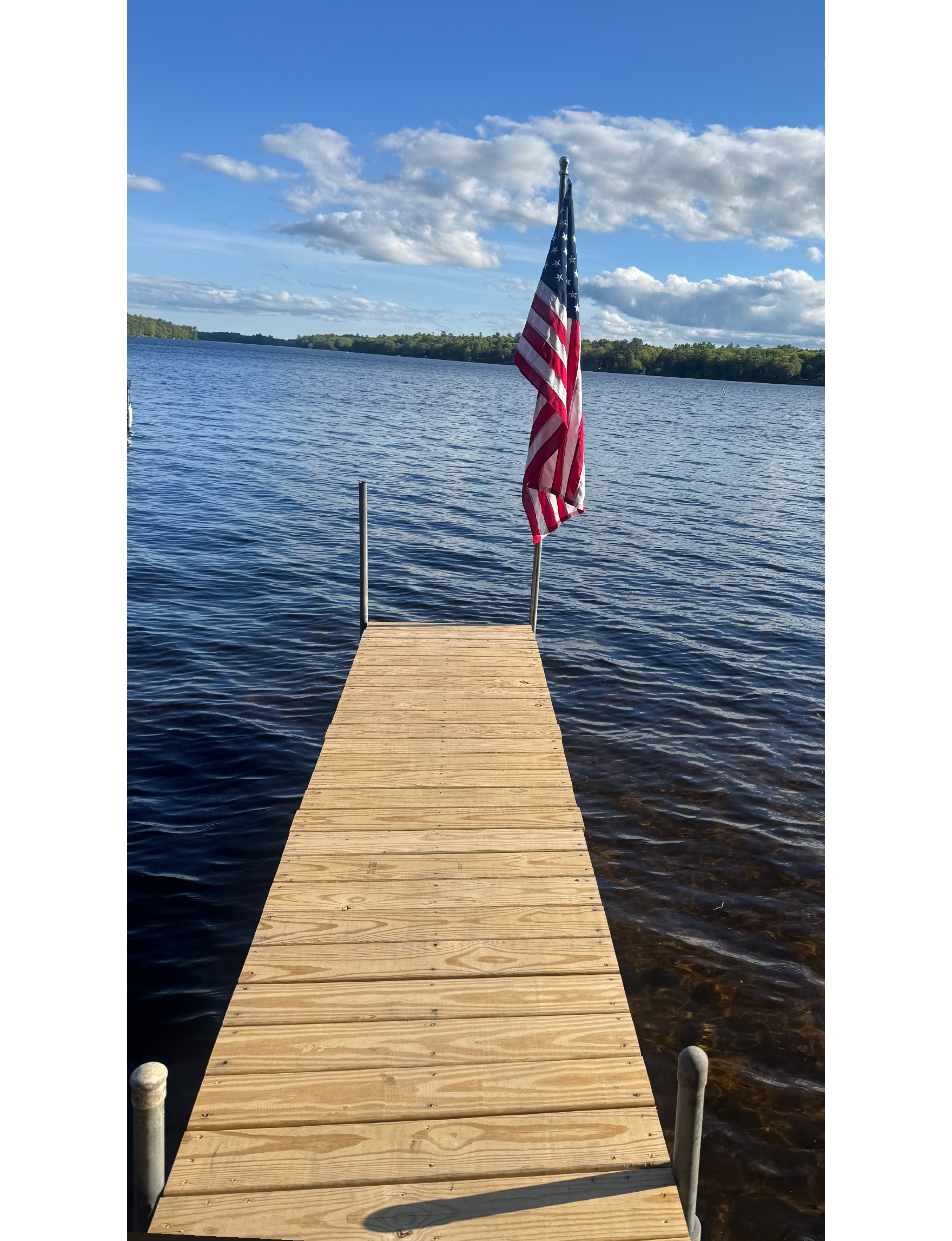dock on a lake with American flag