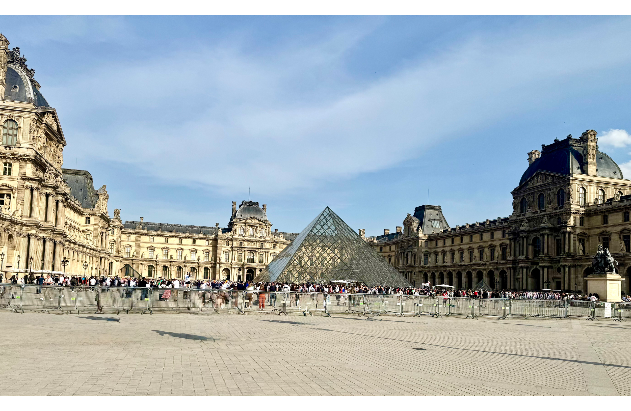 the iconic Louvre Museum (Musée du Louvre) and its famous glass pyramid set in the main courtyard (Cour Napoléon) in Paris, France