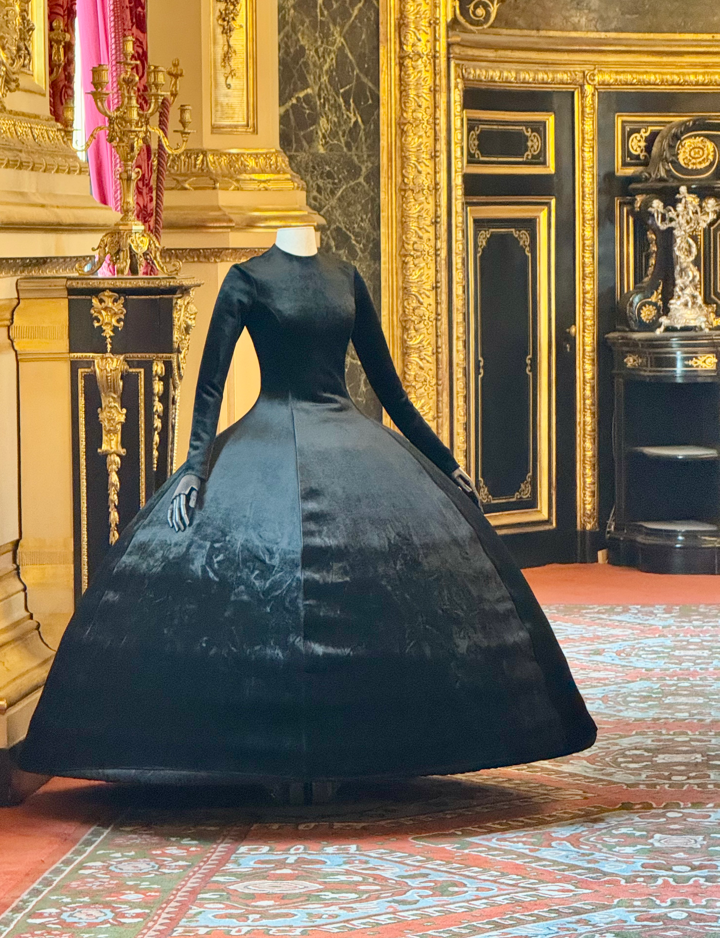this black velvet ball gown by Demna for Balenciaga features a dramatic, structured voluminous skirt and was showcased during the historic "Louvre Couture" exhibition at the Musée du Louvre in Paris