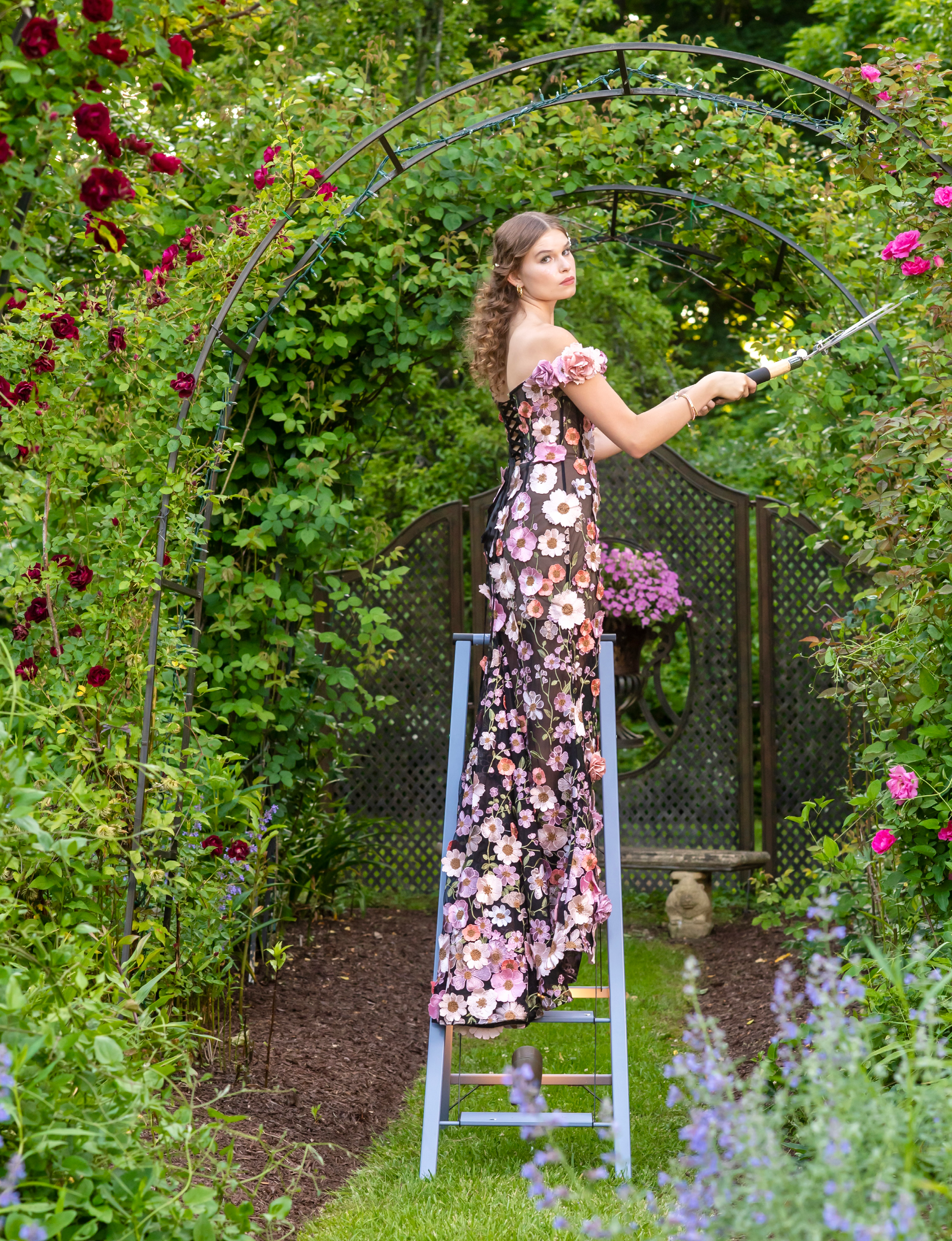 model Samantha Lee posing in garden in summer