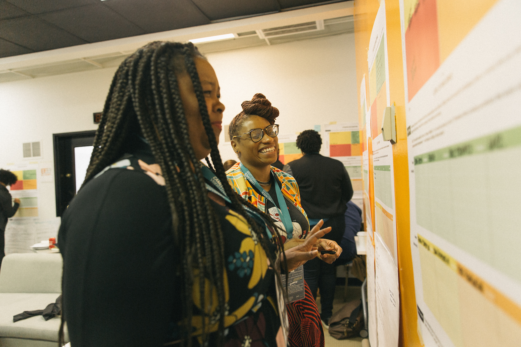 Fellows Antionette and Nicole share a moment during a workshop.