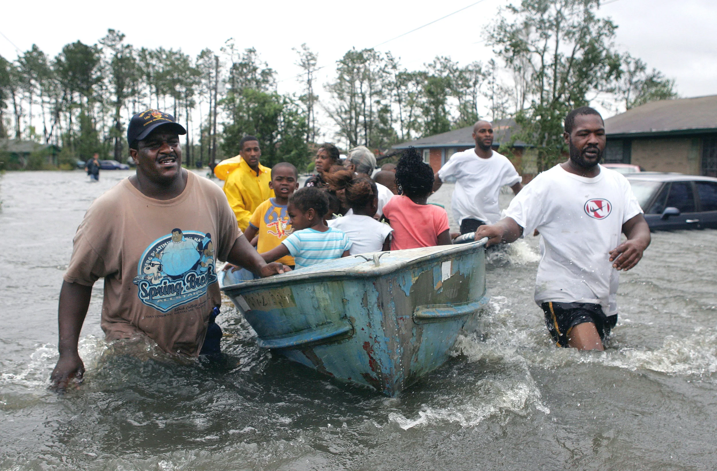 Rescuers use an old row boat to evacuate children and an elderly woman from their flooded homes in Gulfport, Miss., after Hurricane Katrina struck the Gulf Coast Monday, Aug. 29, 2005. ASSOCIATED PRESS.