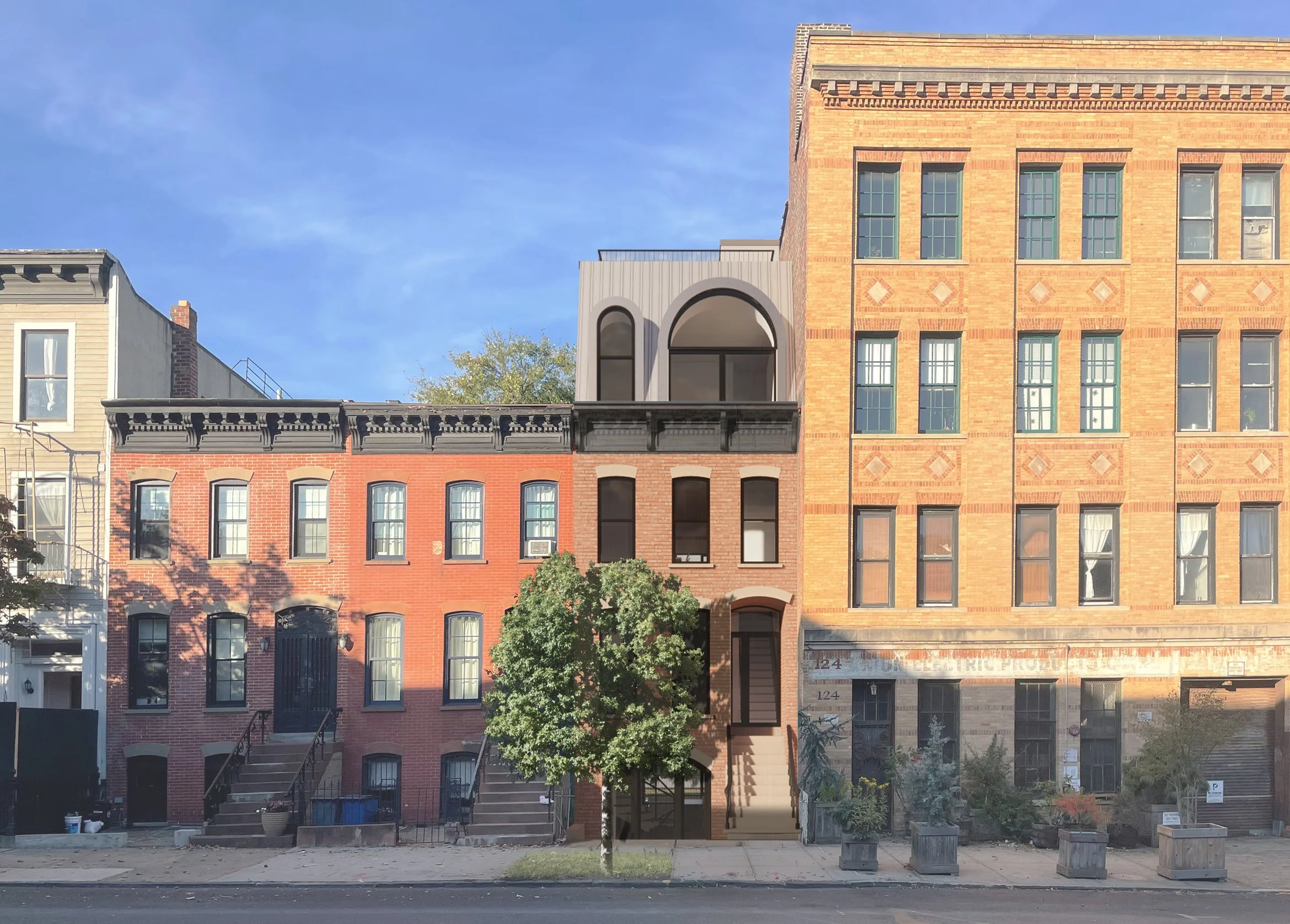 Row of urban buildings with different brick facades, a tree in front, and a clear blue sky.