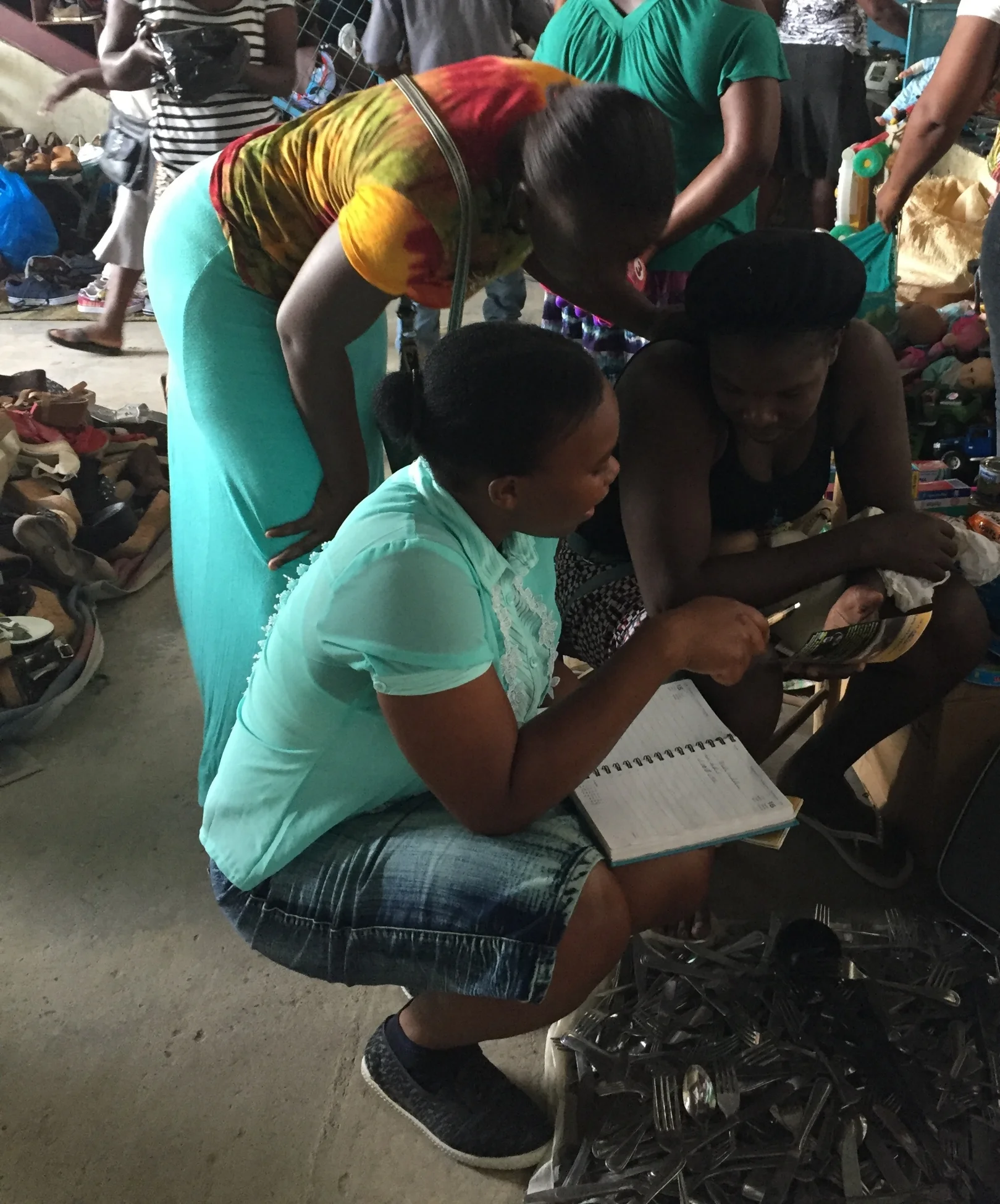  Nelly talking with two haitian women about the SunKing lanterns. 