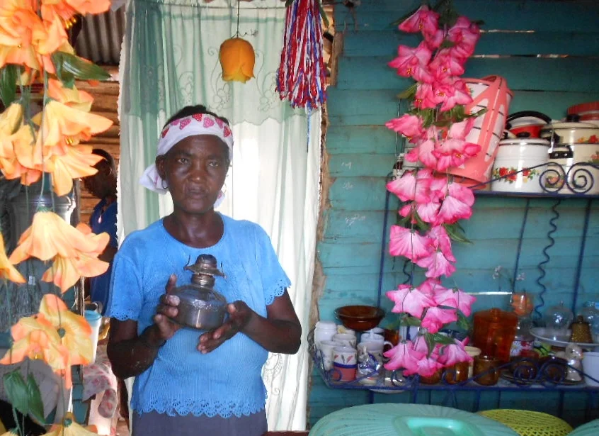  Elderly Haitian woman with a traditional kerosene lamp. 