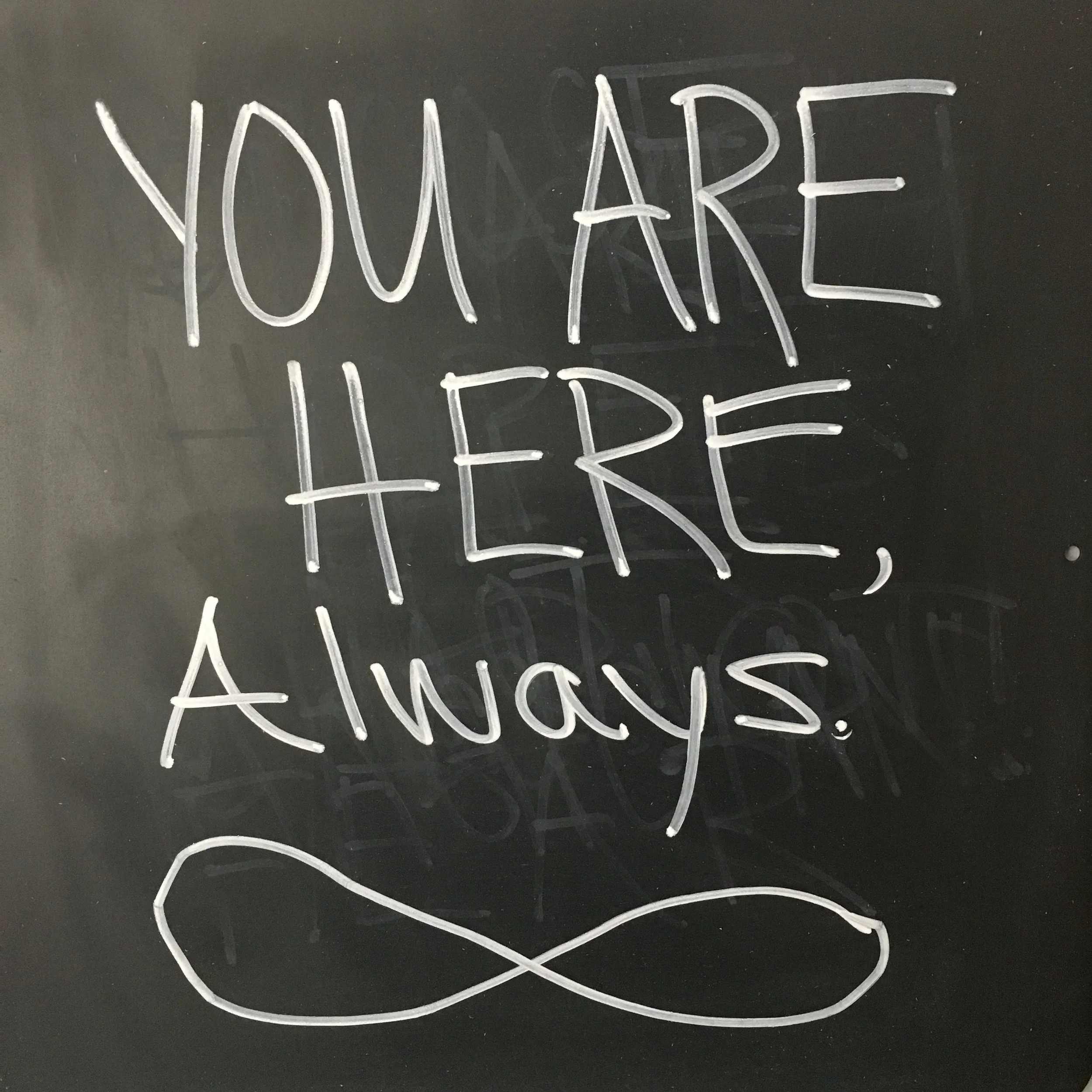 The infinity symbol on the chalkboard above my desk.