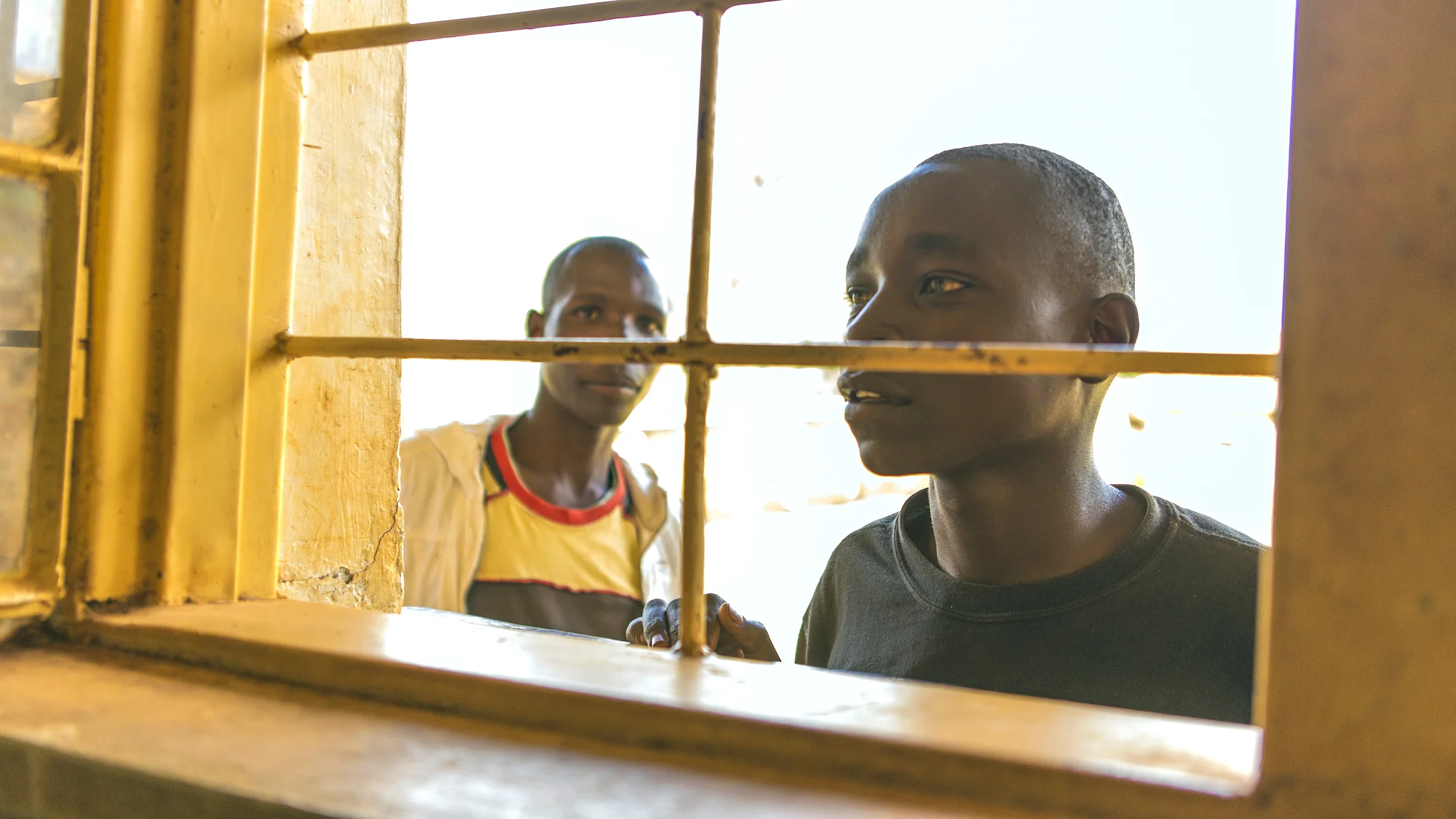 boy-peers-through-window-rwanda-school.jpg