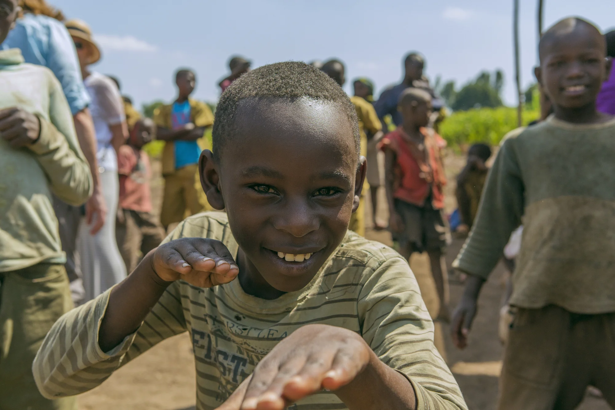 boy-makes-hands-rwanda-village.jpg