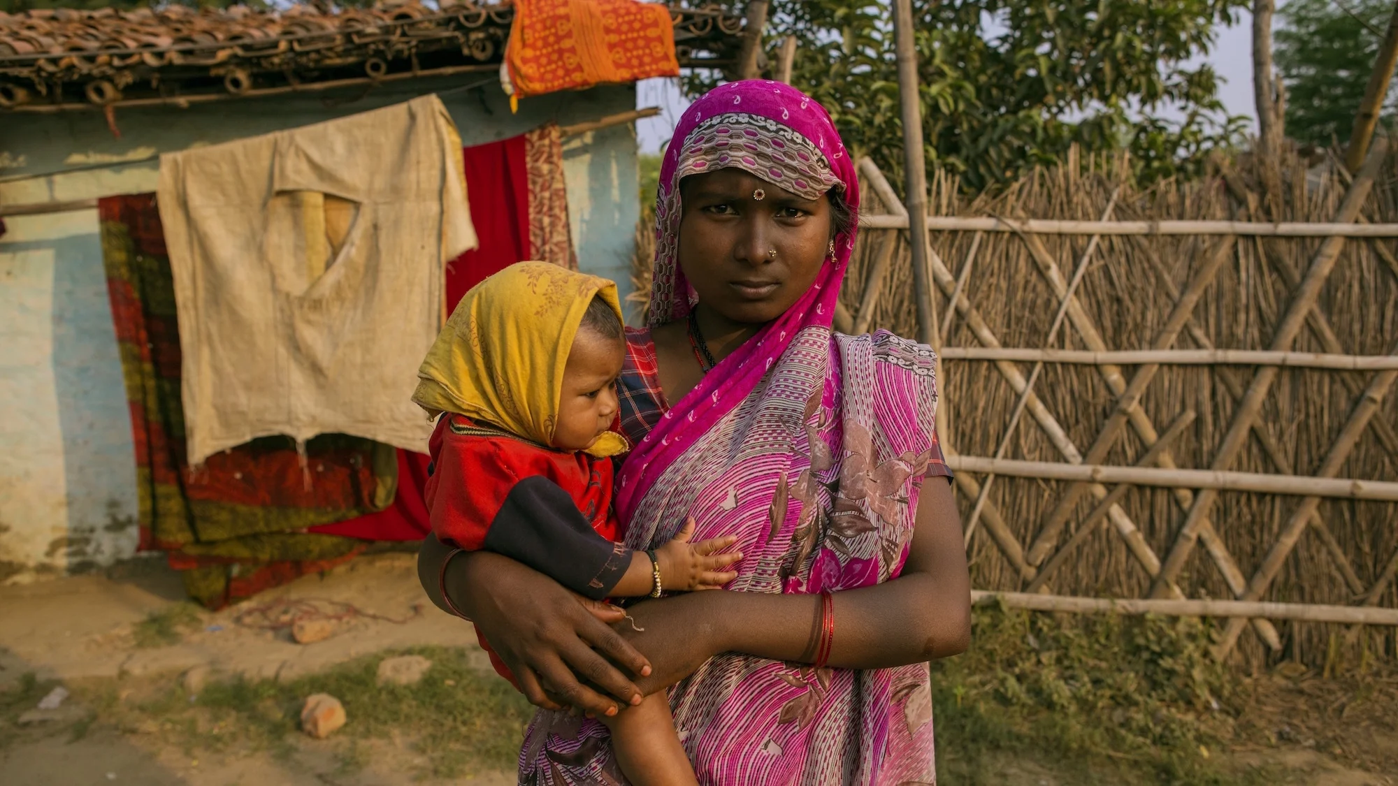 woman-holds-child-colors-india.jpg