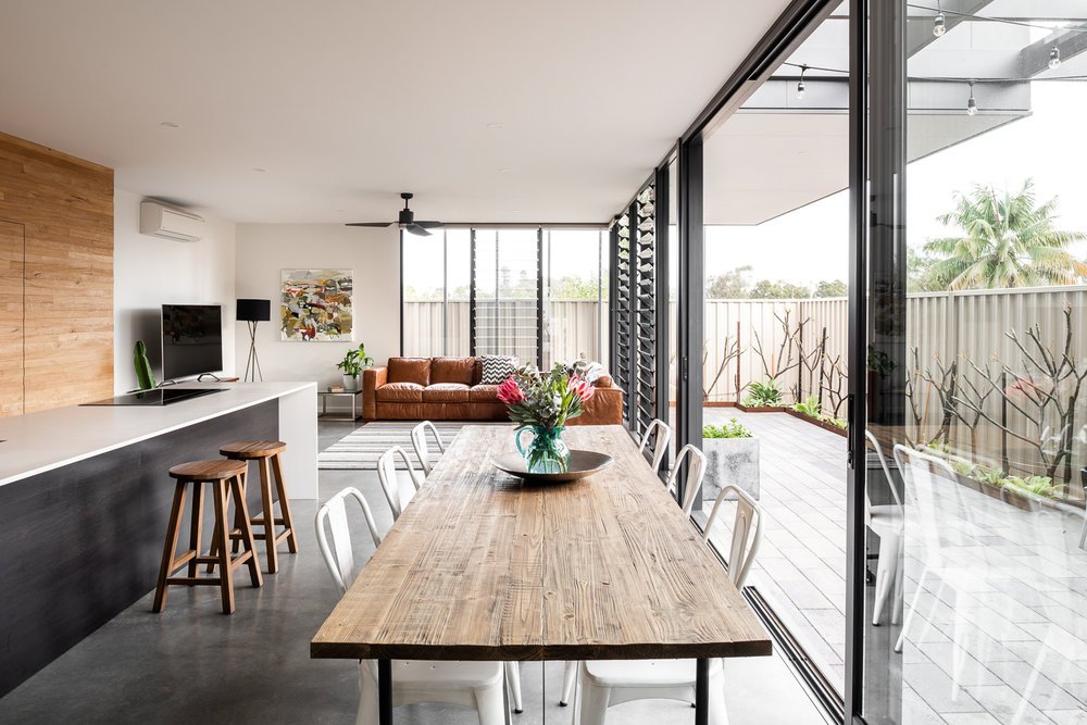 Concrete floors and long timber dining table