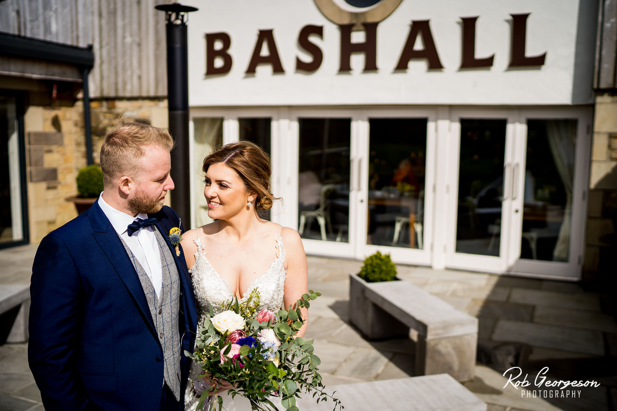 Bride and Groom at the main entrance to Bashall Barn