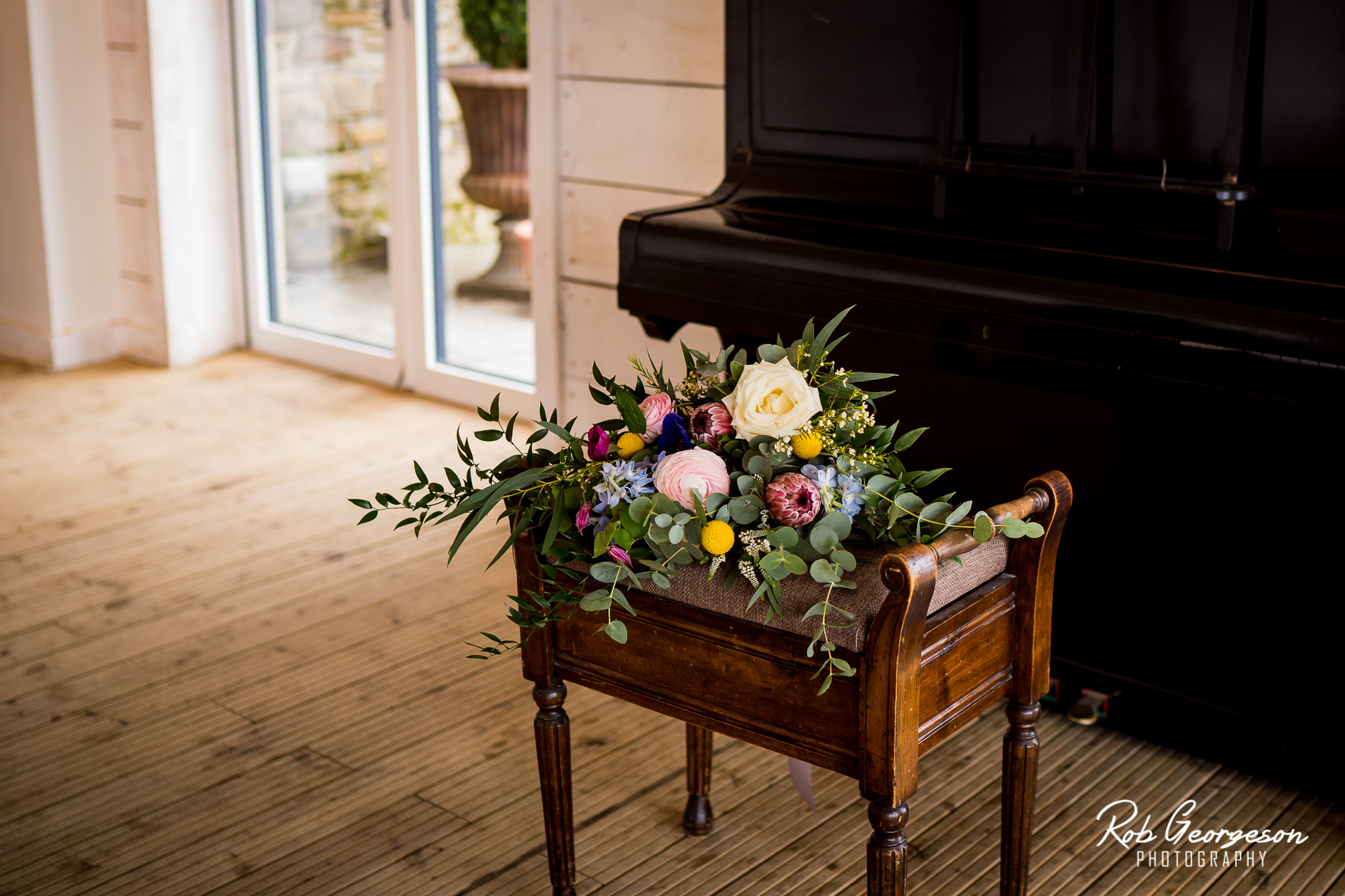 bride bouquet of flowers on a piano stool