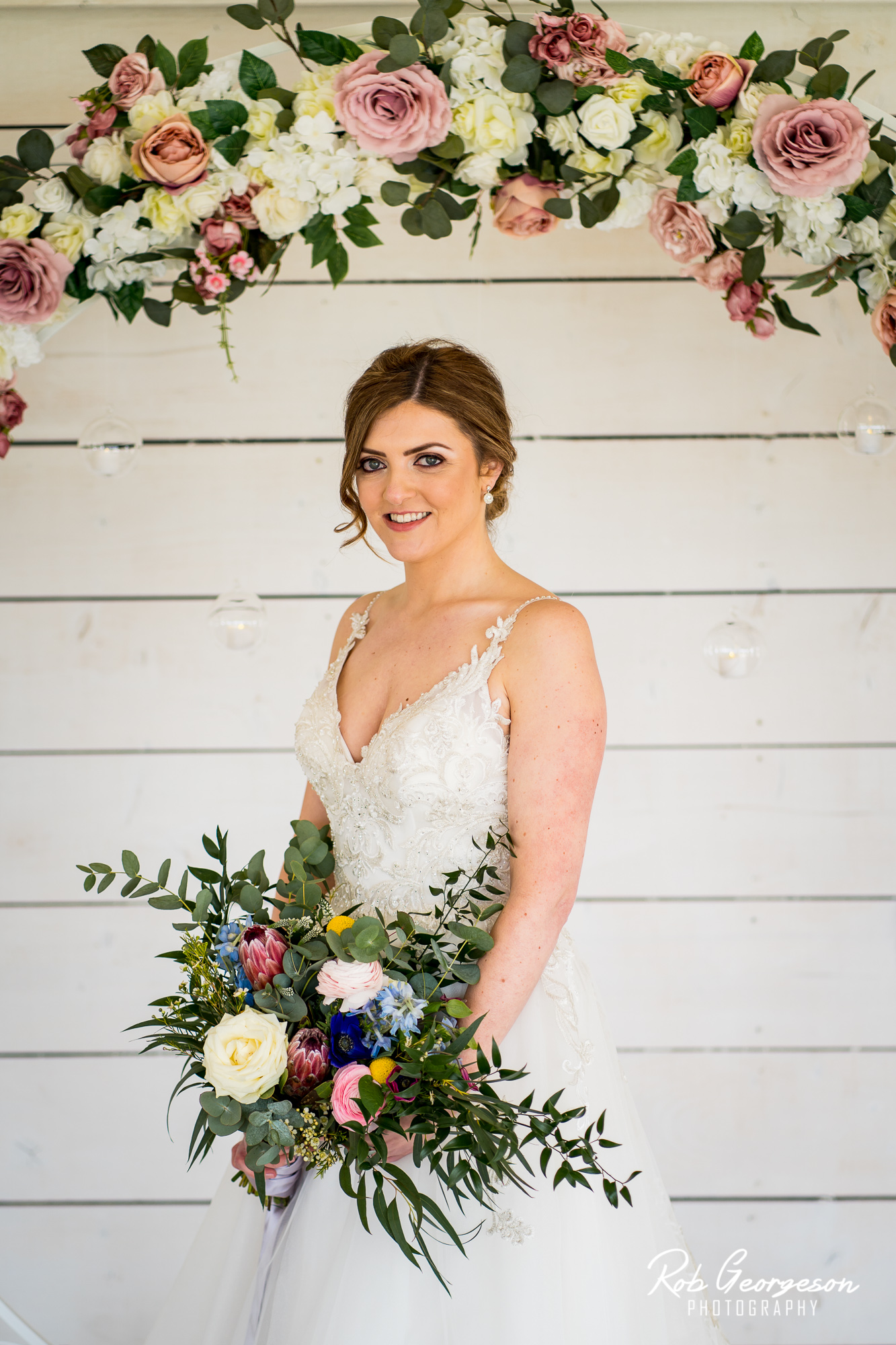 wedding at Bashall barn with a flower wall and bride