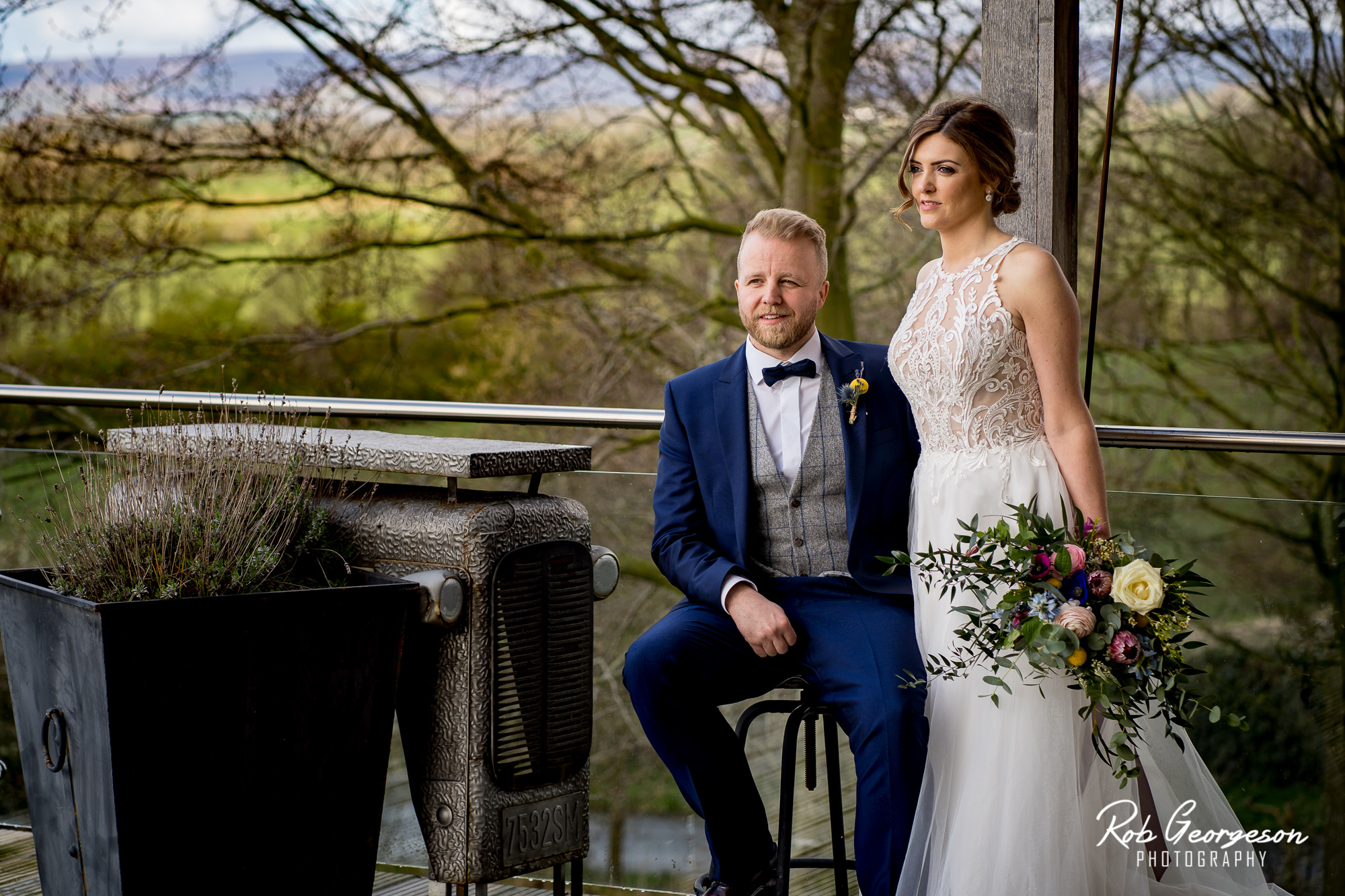 bride and groom together on the balcony of bashall barn