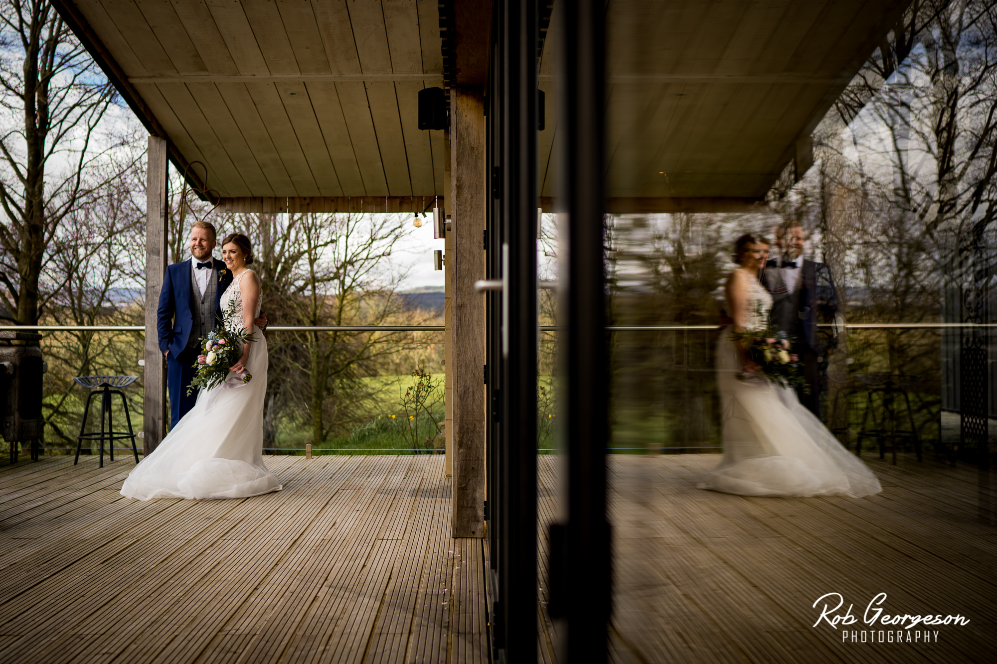 patio door reflection of bride and groom at bashall barn