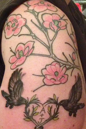 This tattoo I for my children and my husband and I. I have endometriosis. I had a lot of issues with it when I was younger and more than one dr. informed me that having kids would be hard. The were incorrect. So this is a BARREN magnolia branch (thus the lack of leaves) with my 6 blossoms. And one small start of a bud to not forget the one loss we had. The birds are for my hubby and I, with our initials in the branch. That branch of course has leaves.
