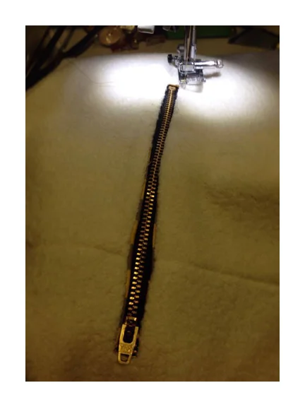 Now lay your zipper into the slit and bump the closed zippers pull up close to one edge.