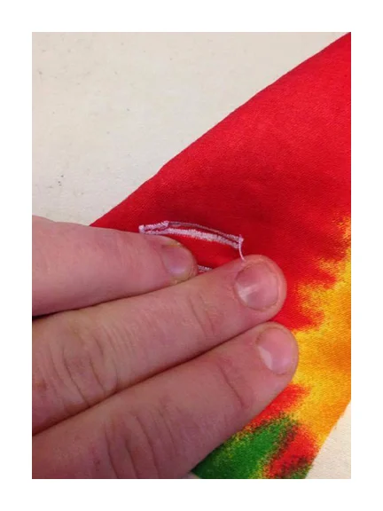 Not far from the tag I like to stitch a small vertical button hole through the lining and interior of the jacket. this hole allows me to plug earbuds into my phone and still securely zip my phone closed. I am also able to put a portable charger in one side of the jacket and my phone in the other side and connect them to allow charging while out and about while evenly distributing the weight in the jacket.