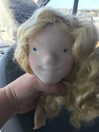 Then stitch the eyes and try on some hair... This was for sure a blonde.