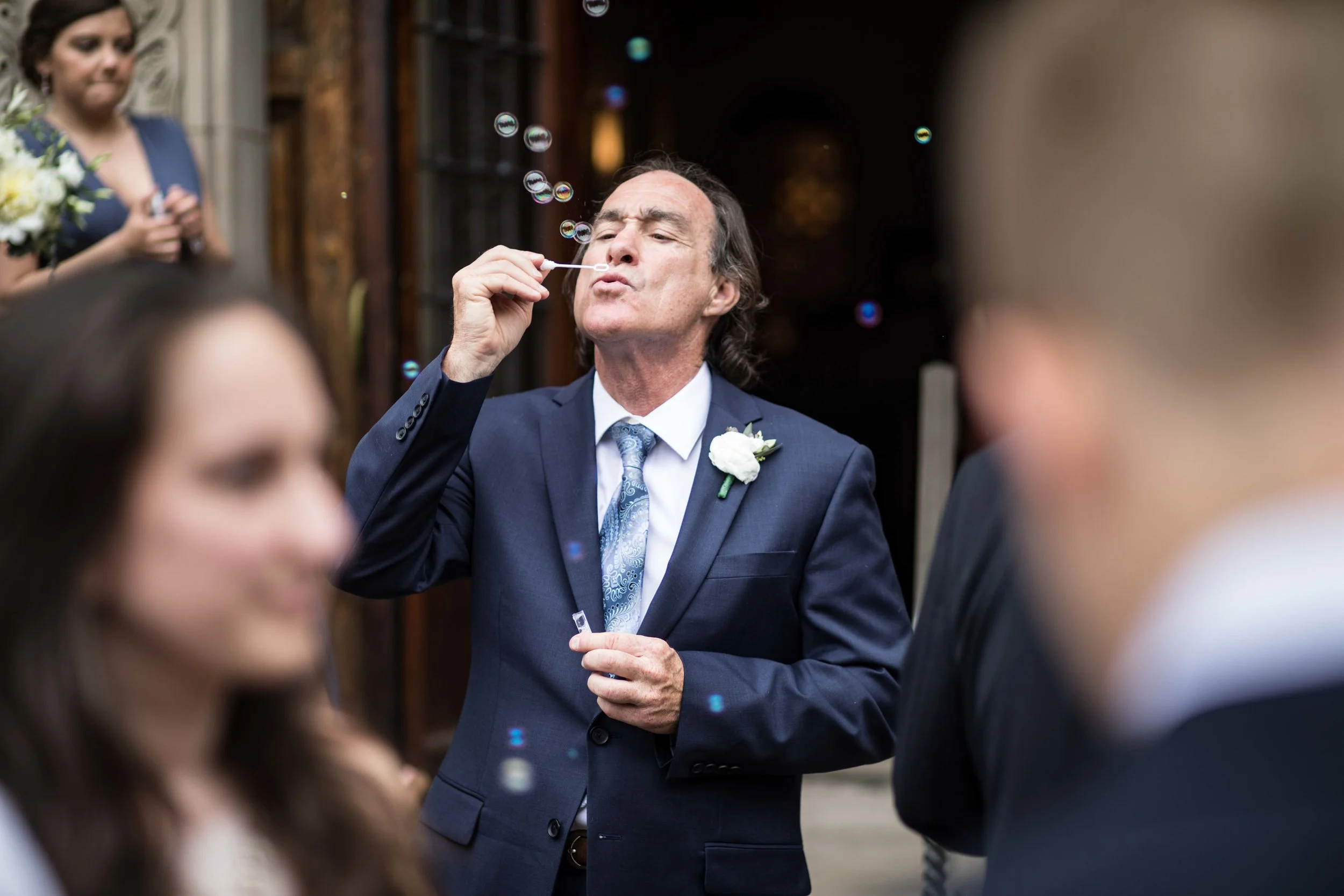 Father of the Groom testing bubble wand