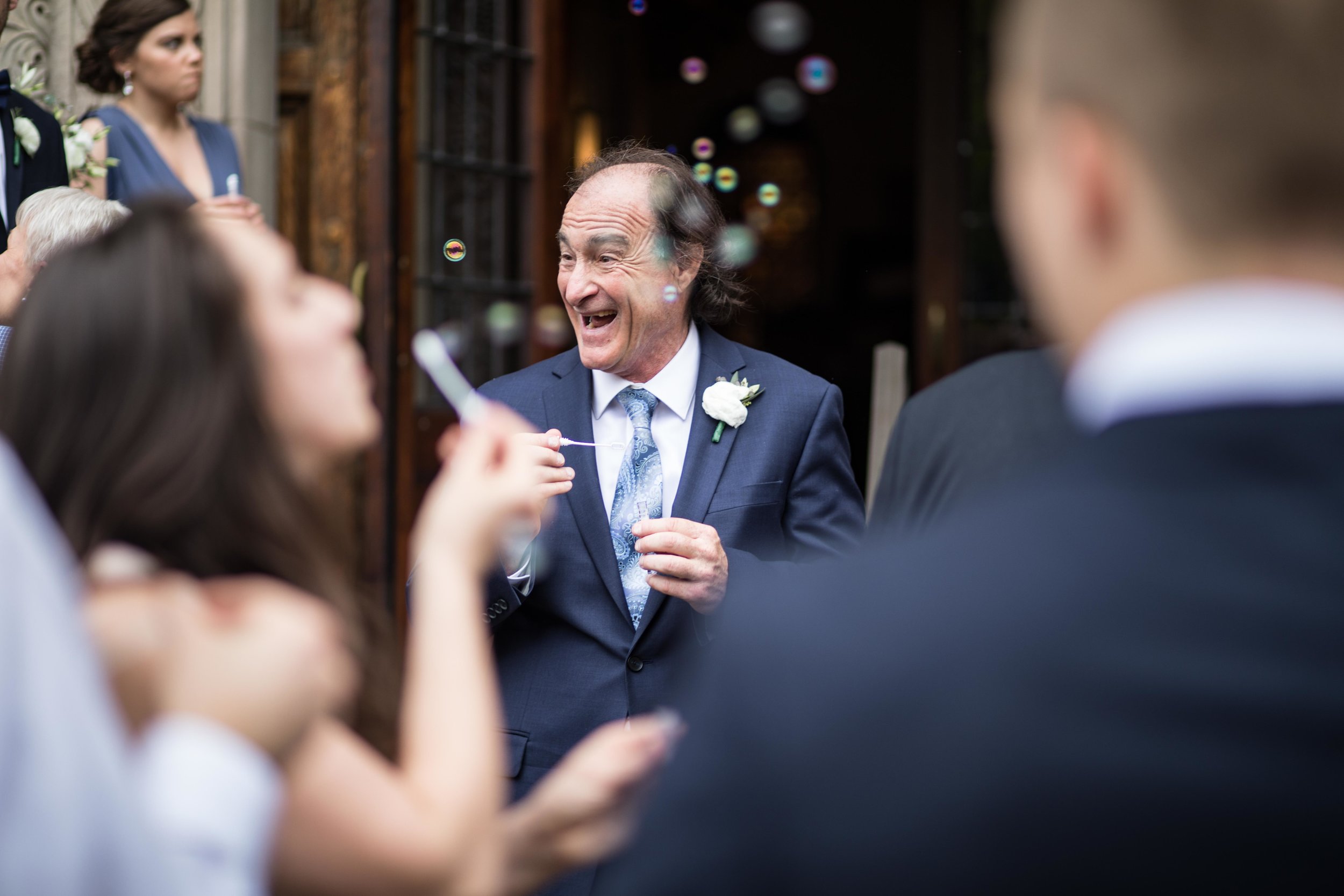  Father of the Groom blowing bubbles and laughing 