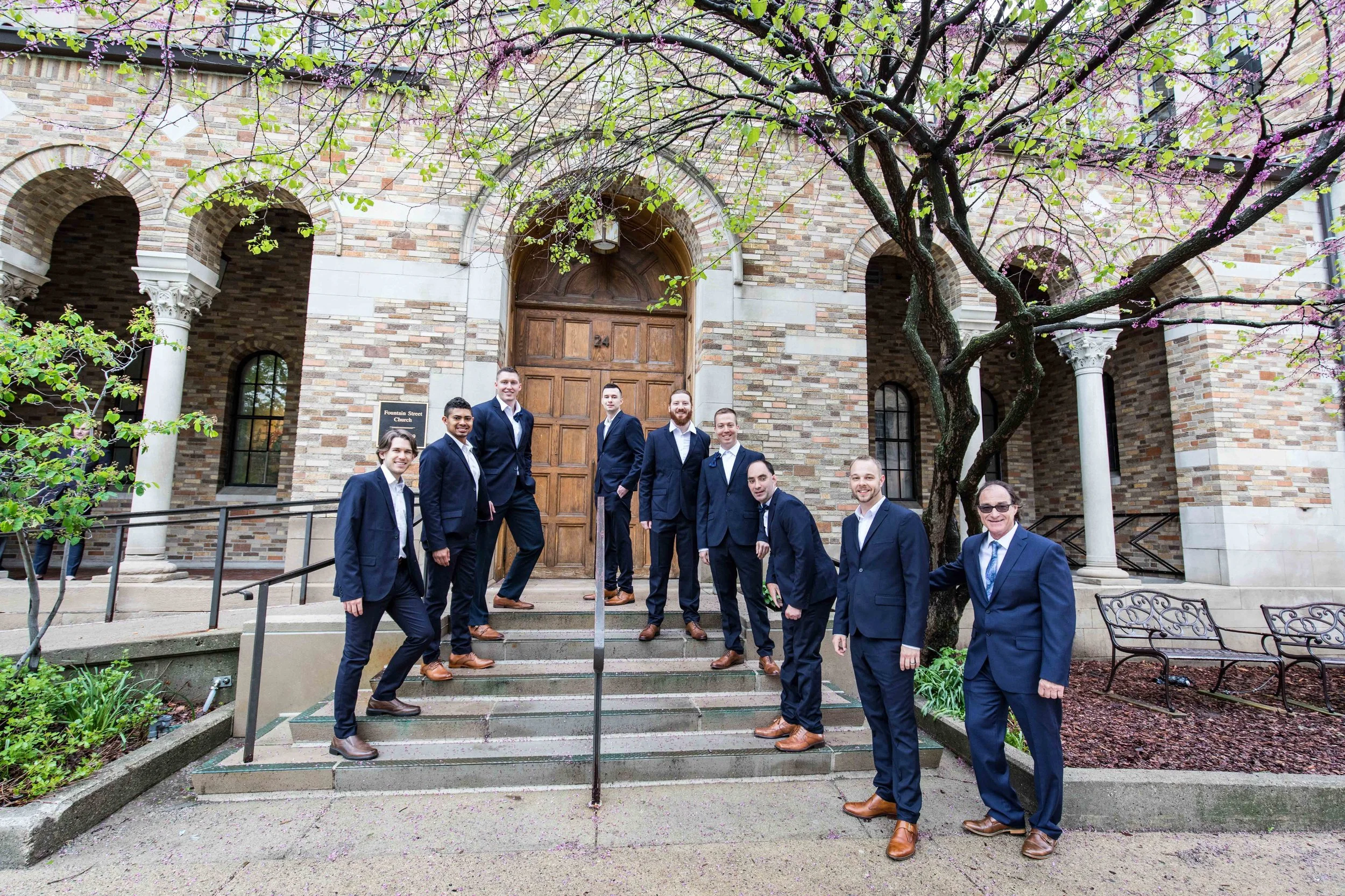 The Groomsmen posing on the steps of the church