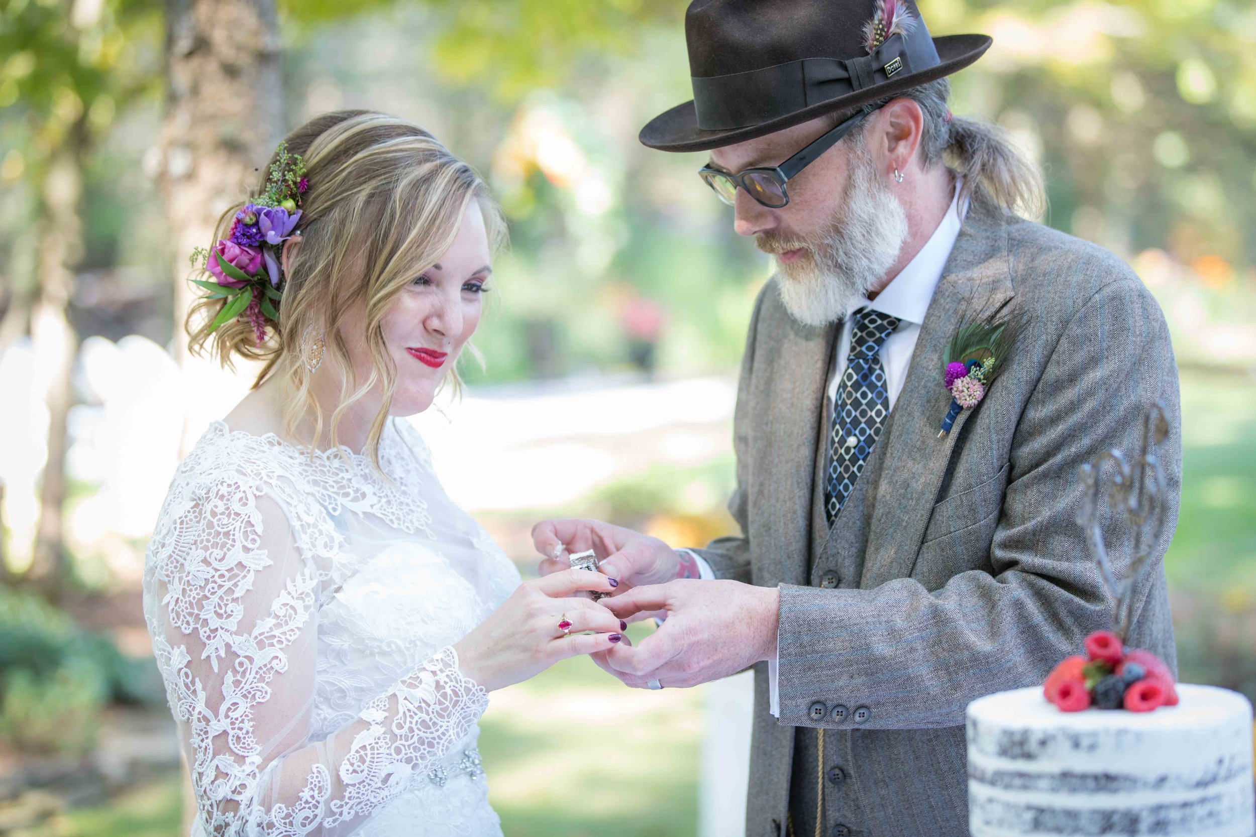  bride and groom gently feed each other cake 