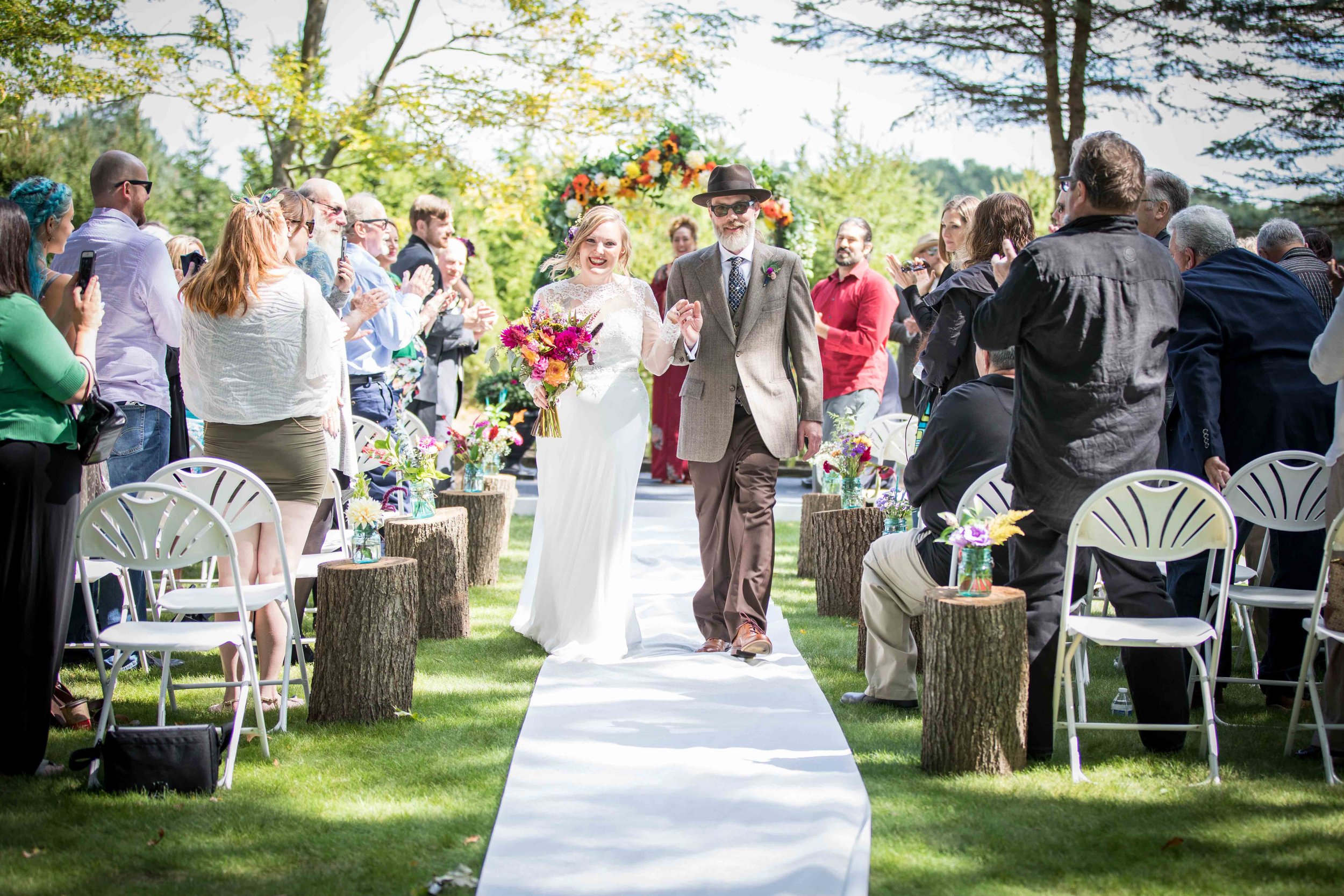  Newly weds walking down the isle in celebration  