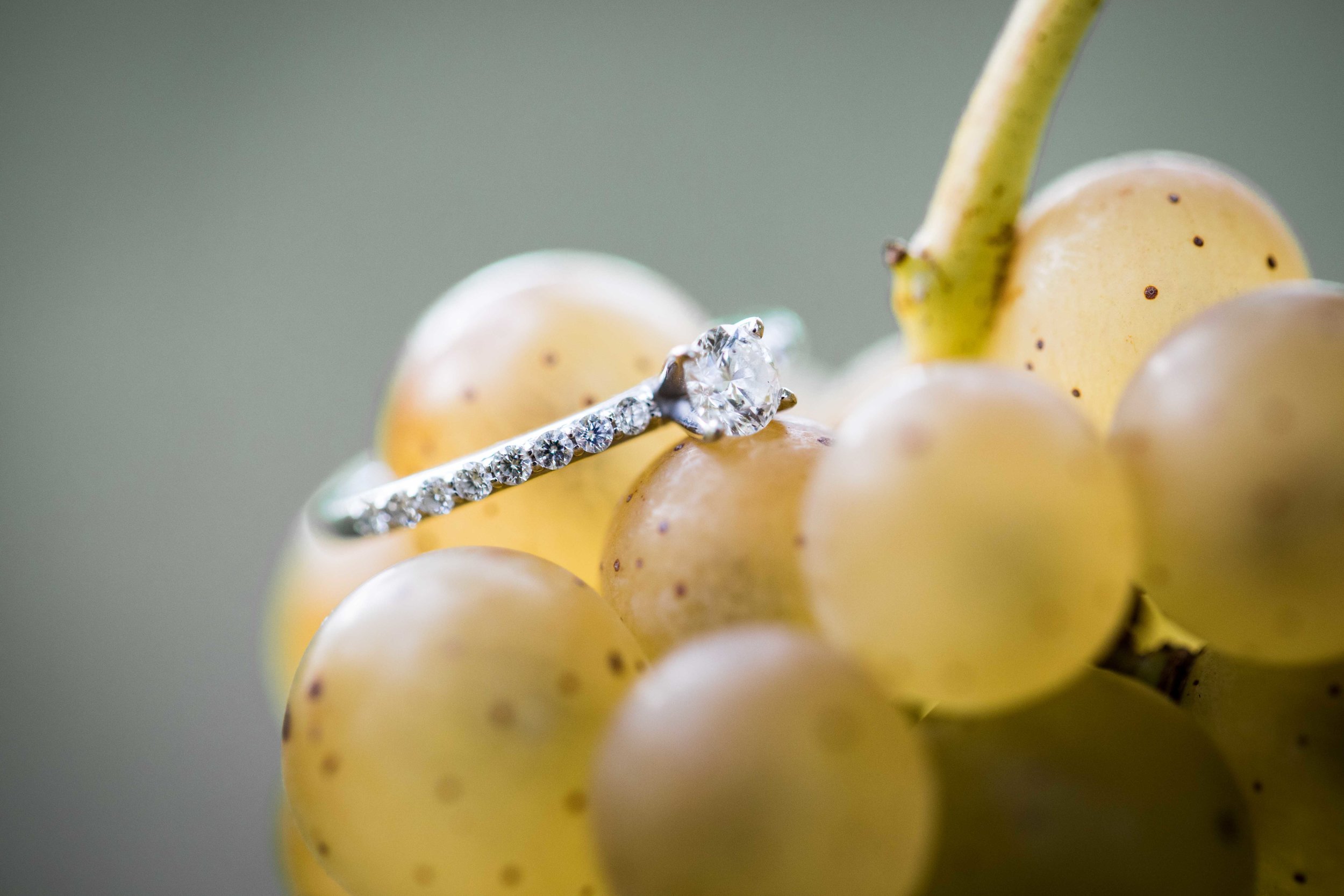  Engagement ring on grapes in the vineyard 