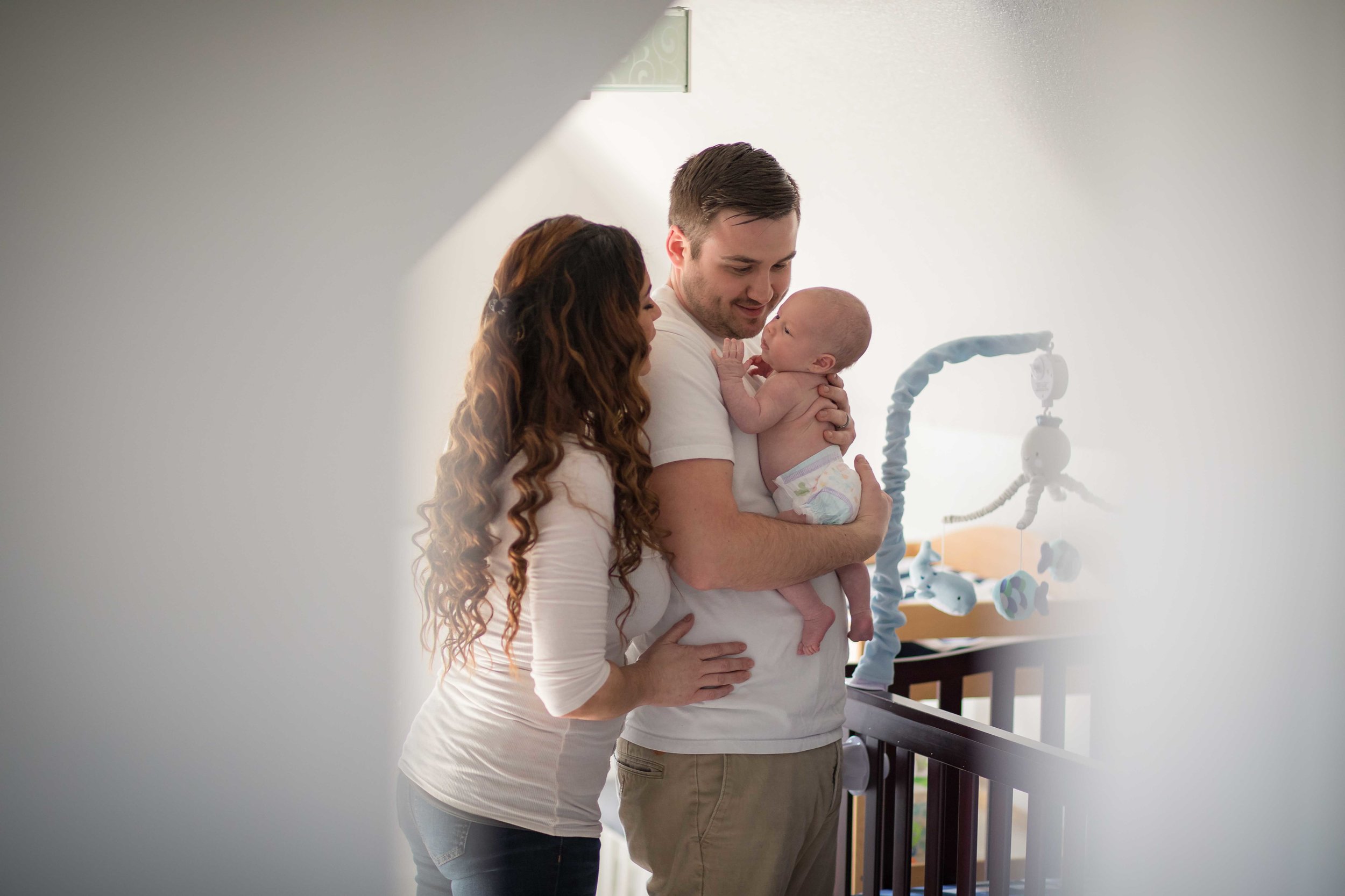  Father holds newborn son in nursery  