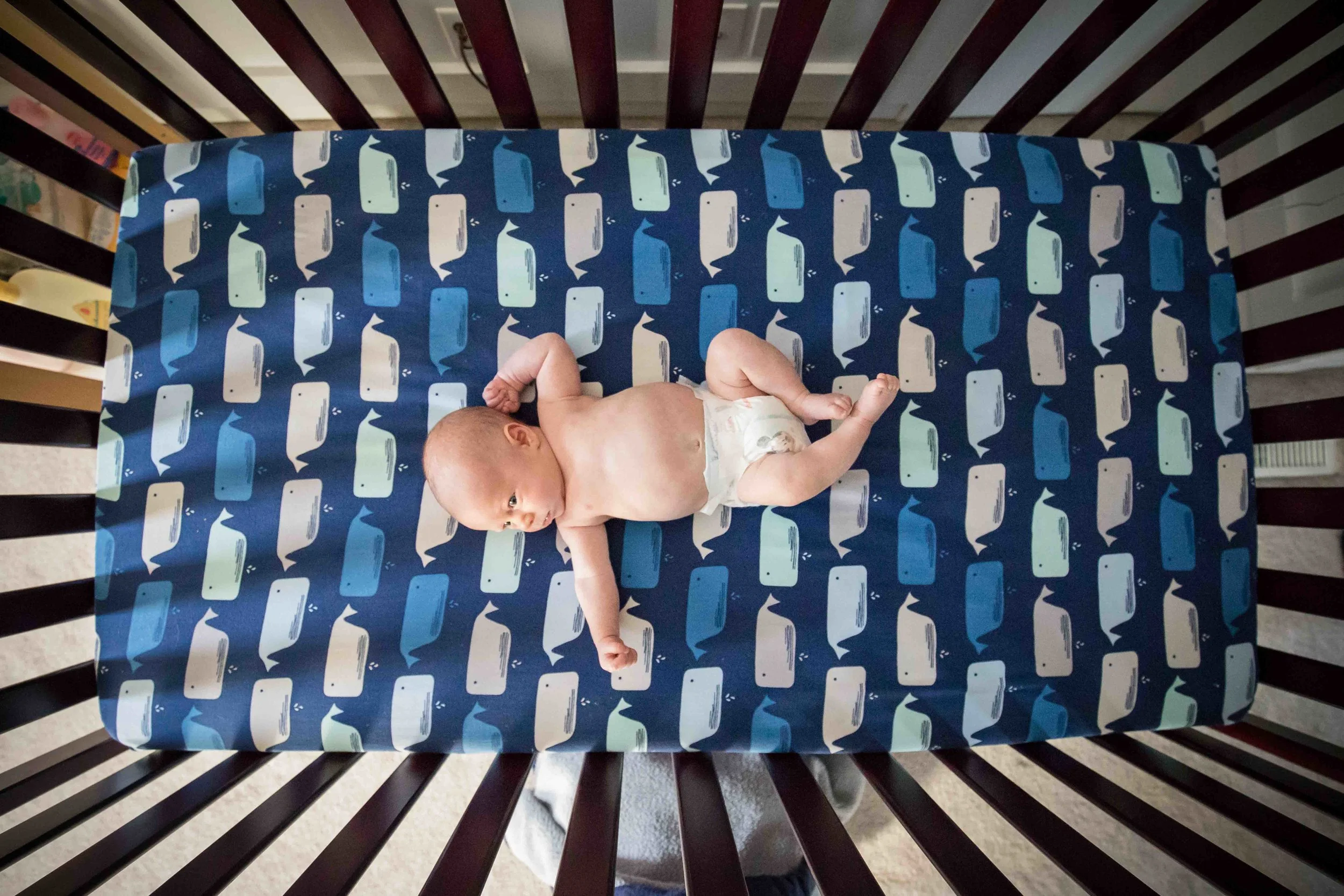 wide angle photograph of baby in crib