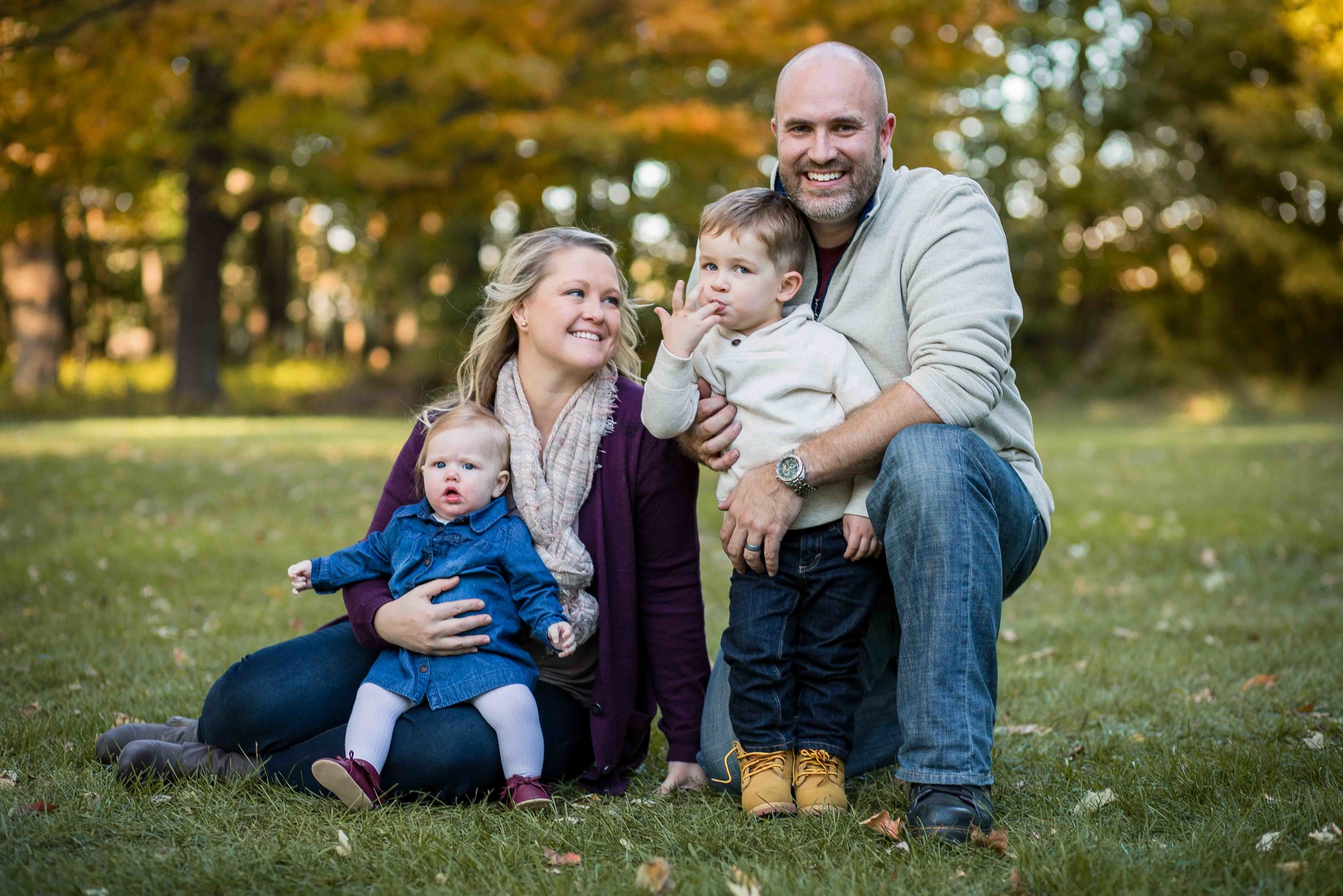  Family of four posing for a fall photo 