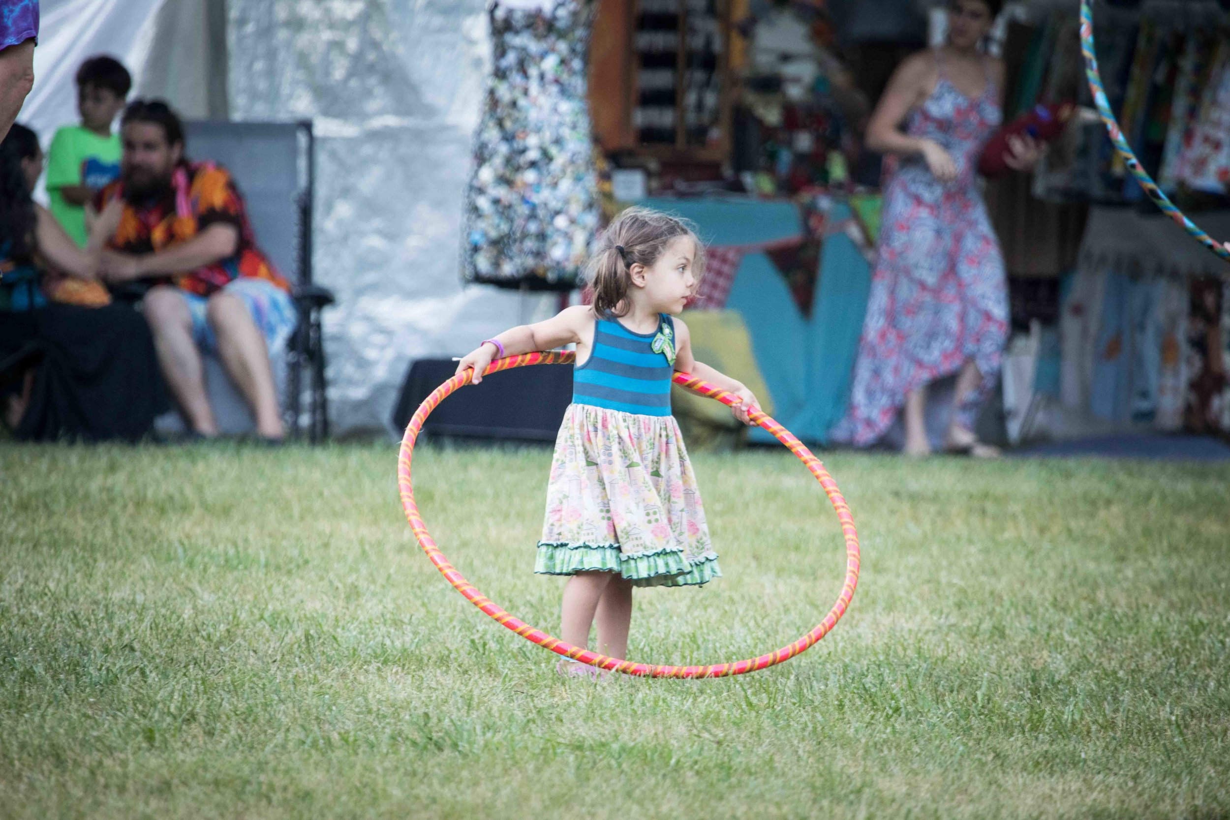  A little girl prepares to attempt the hula hoop  