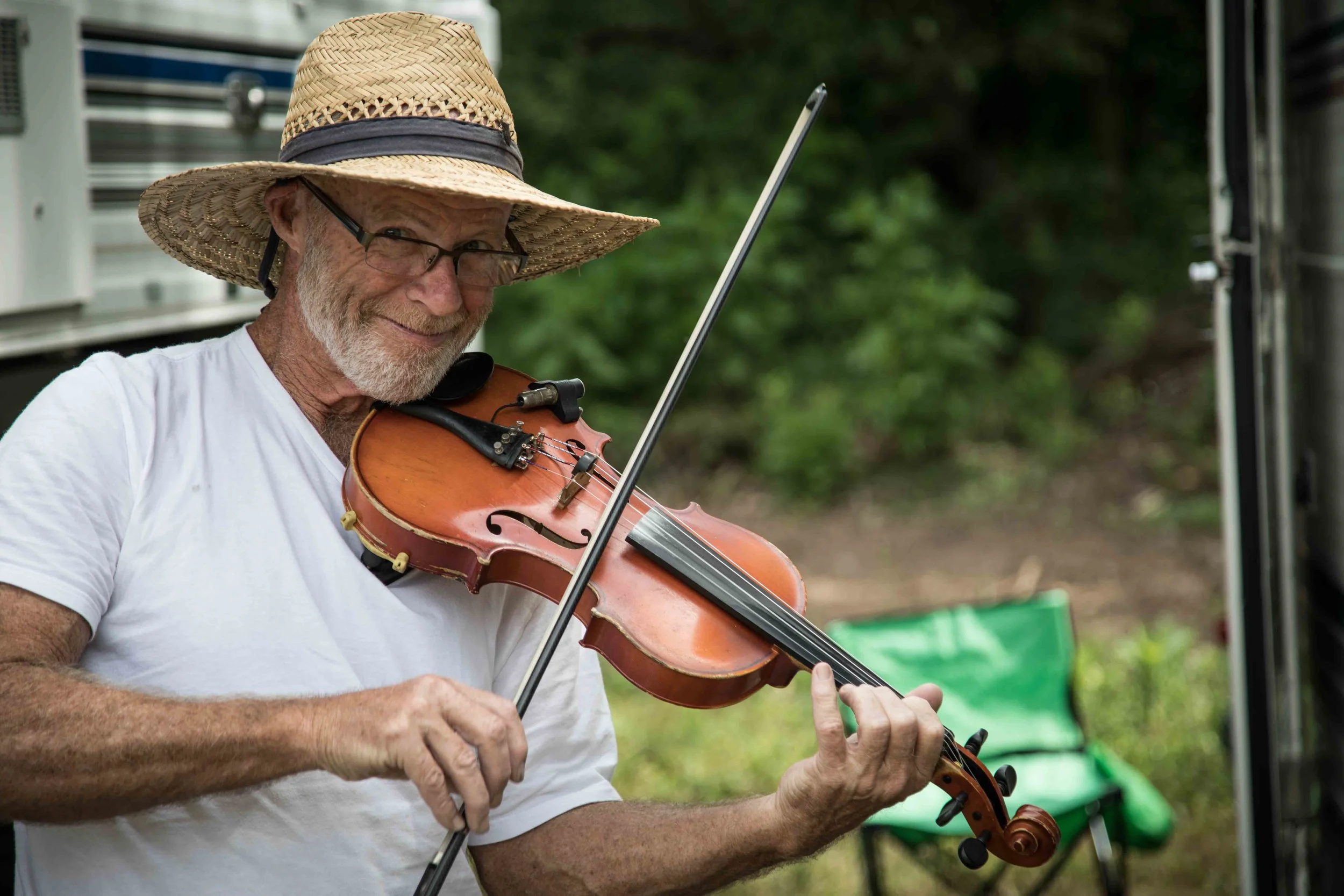 Festival goers bring their own instruments to jam with their tent neighbors
