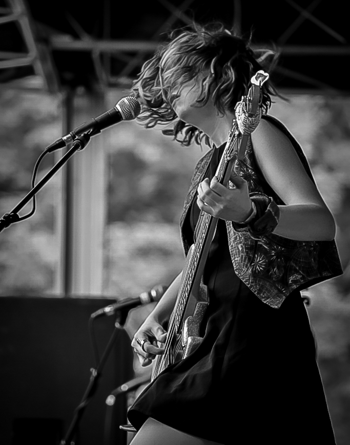  The accidentals performing on stage playing electric bass guitar 