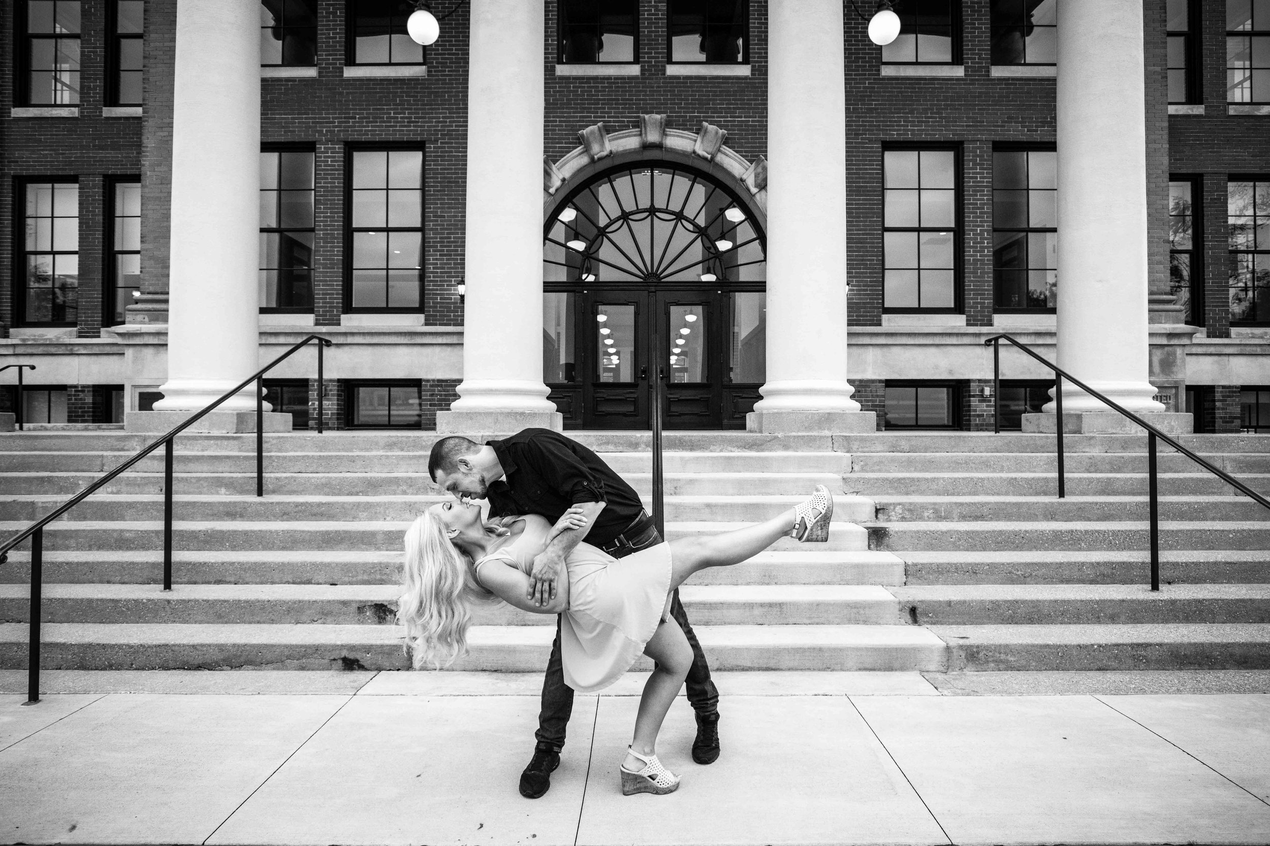  The “Dip Kiss” in front of the steps and tall columns of Old East Hall at Western Michigan University 