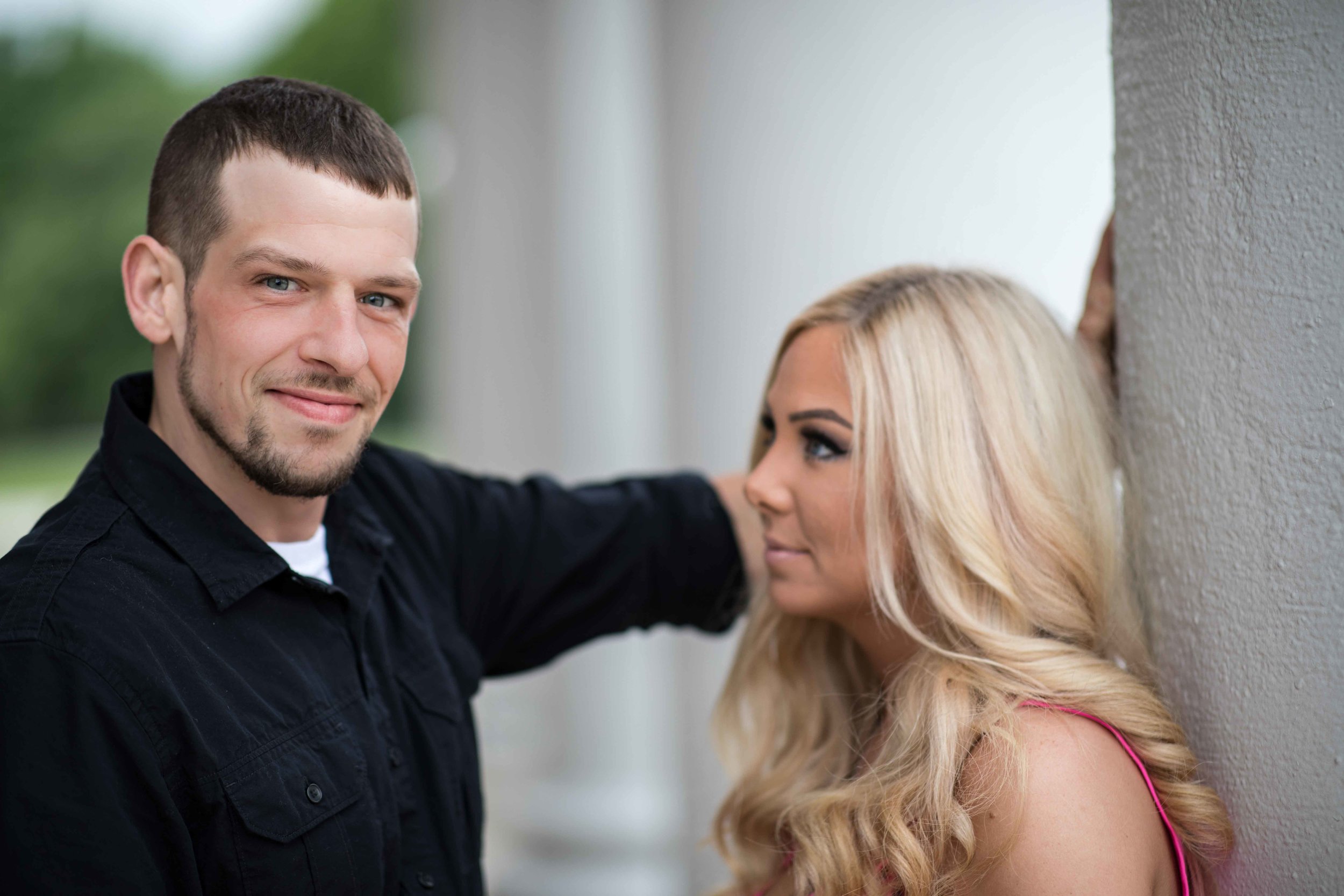  She looks at him with “the look” while he poses for his photograph 