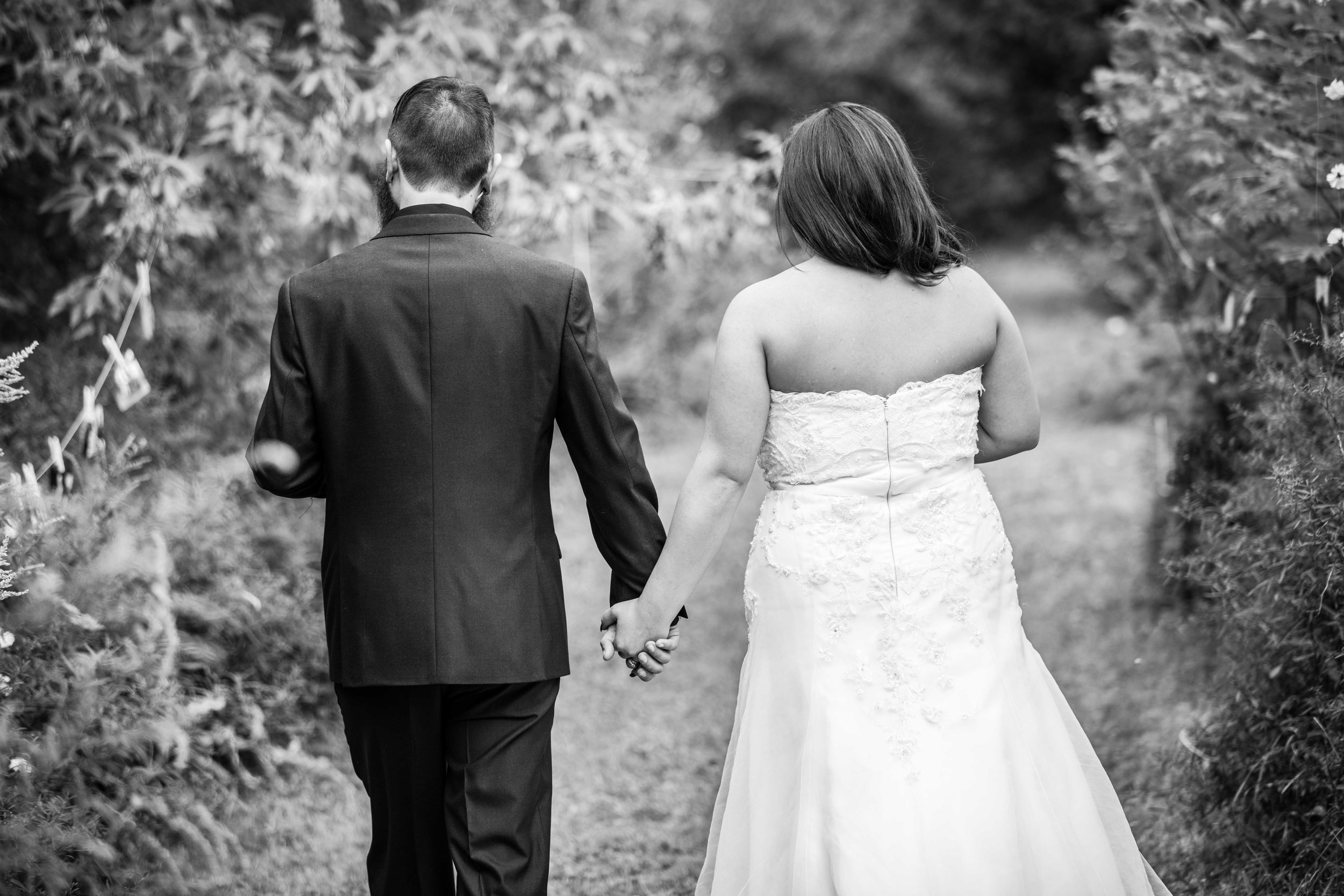 black and white bride and groom walking away.jpg