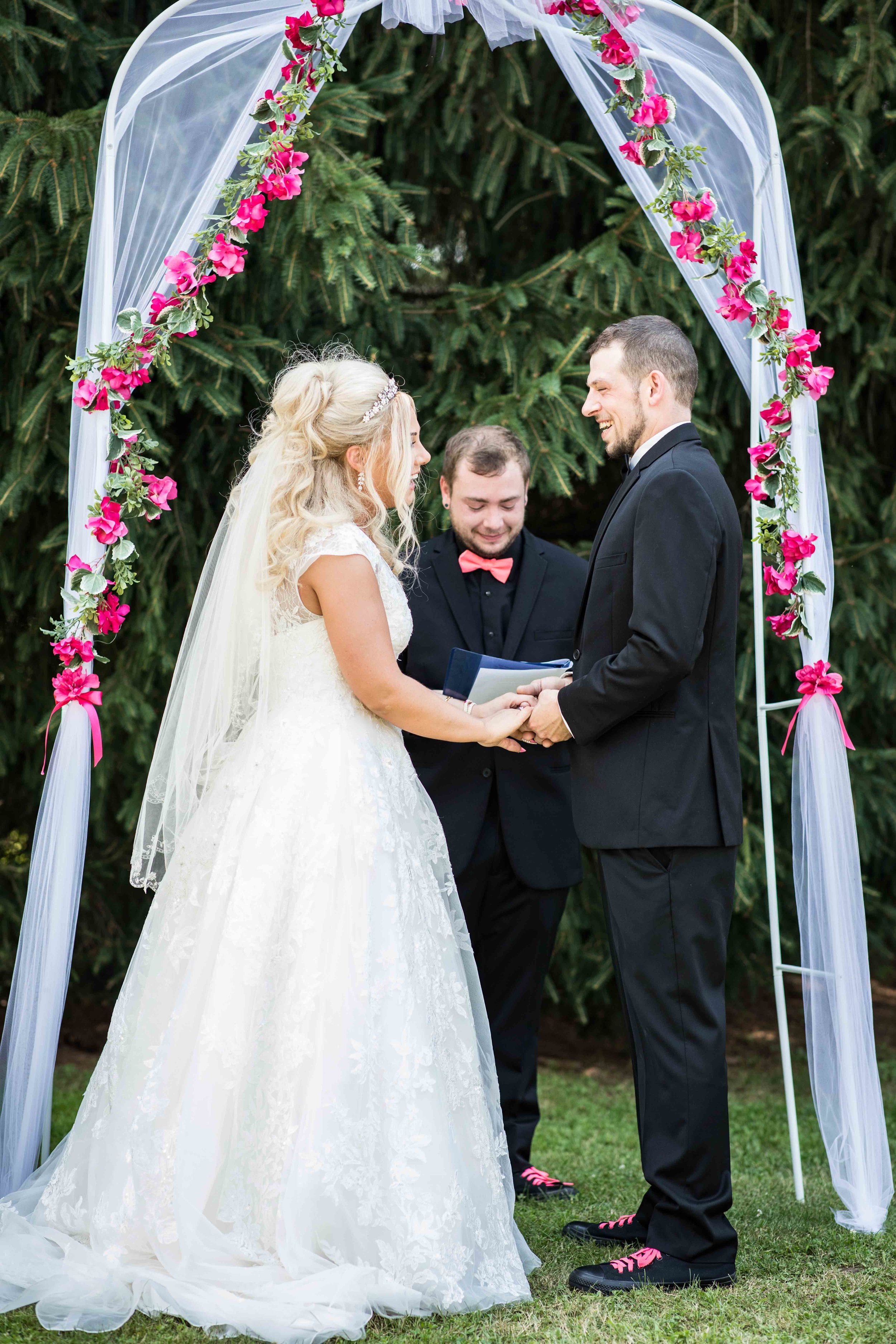  The couple holds hands as they stand together about to be wed 