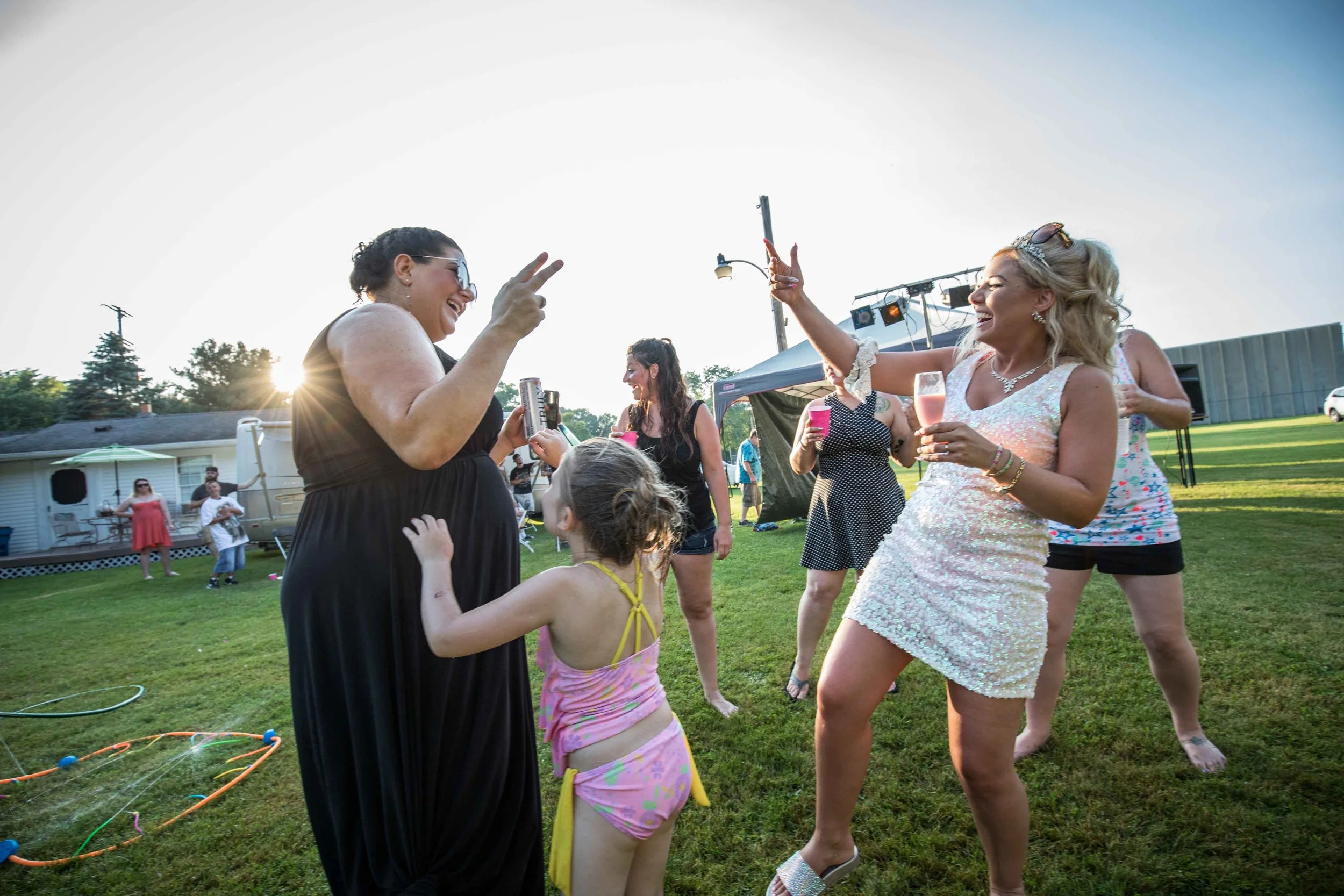 Friends celebrate dancing together in the setting sun