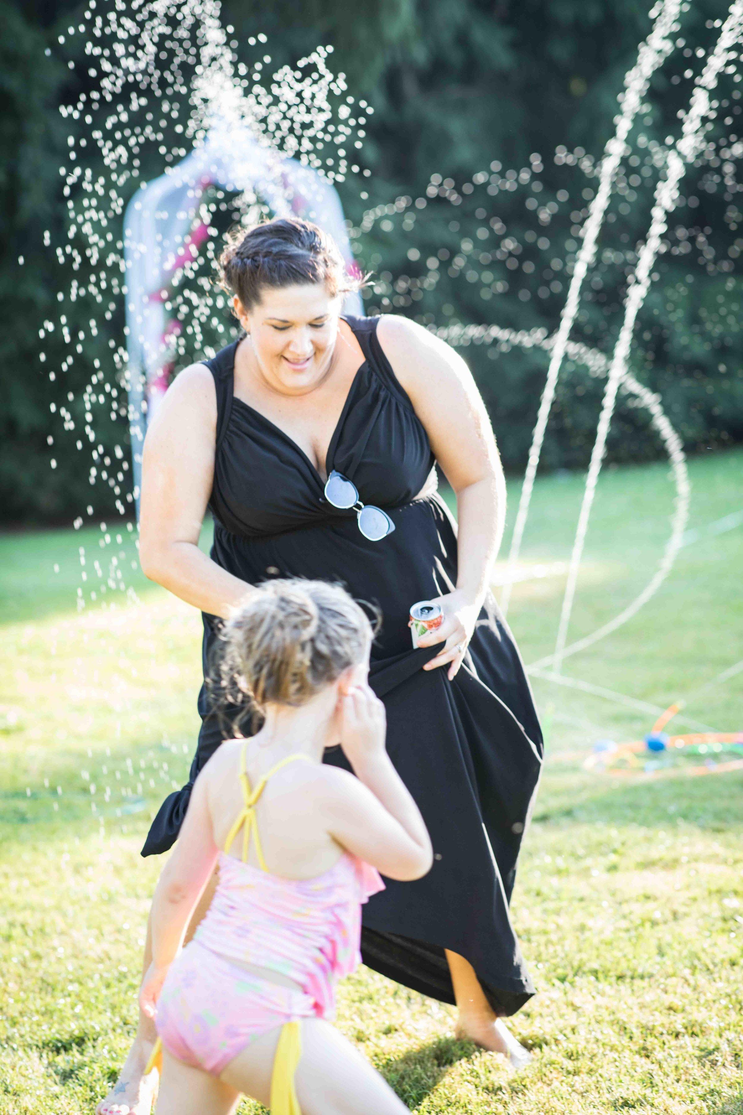  a bridesmaid gets soaked dancing with a little girl in the water 