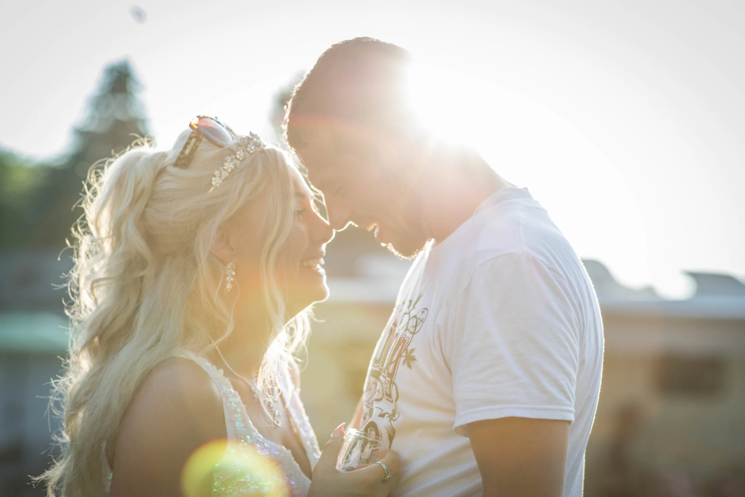 Bride and groom embrace in a setting sun