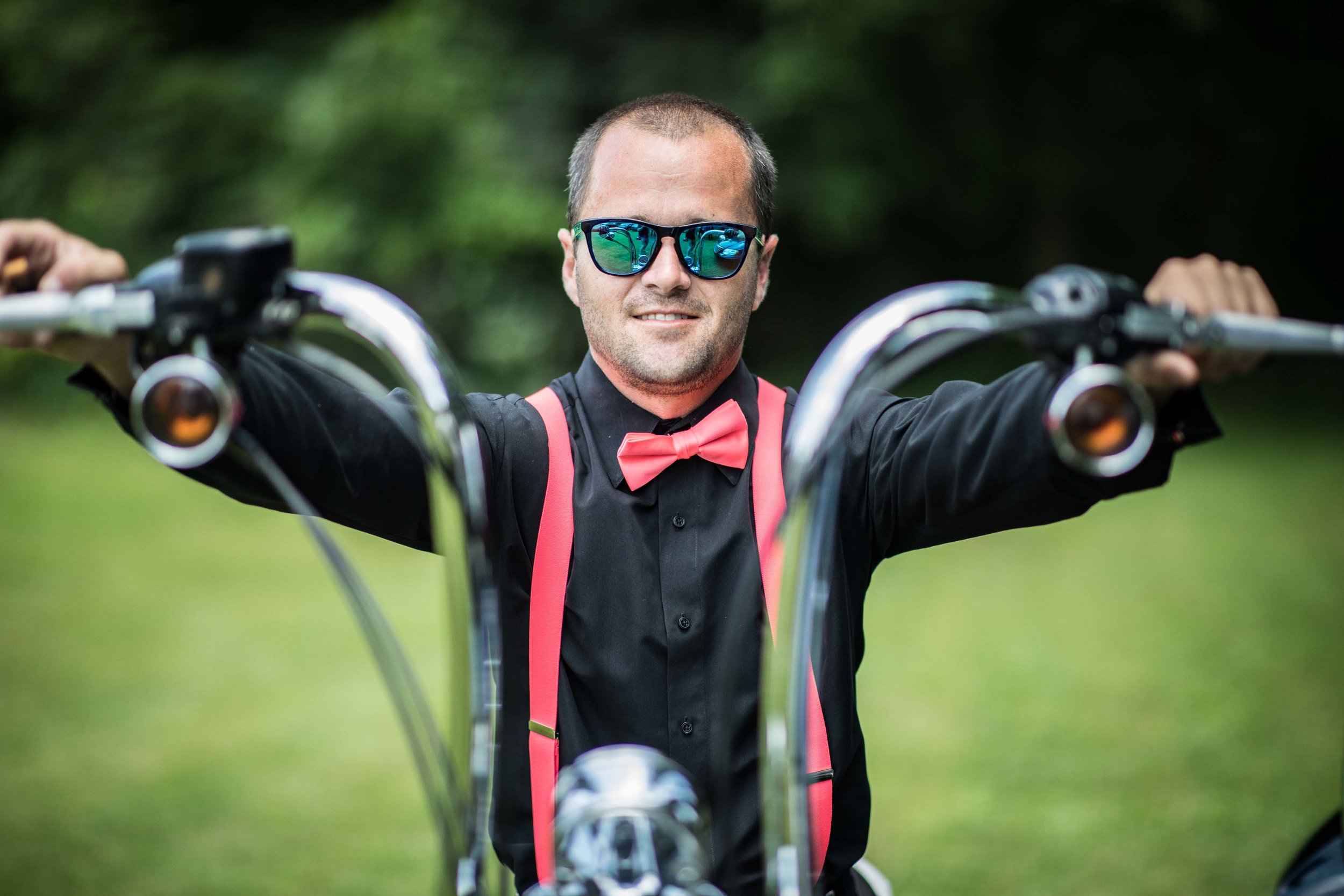 Groomsmen in pink suspenders on motorcycle.jpg