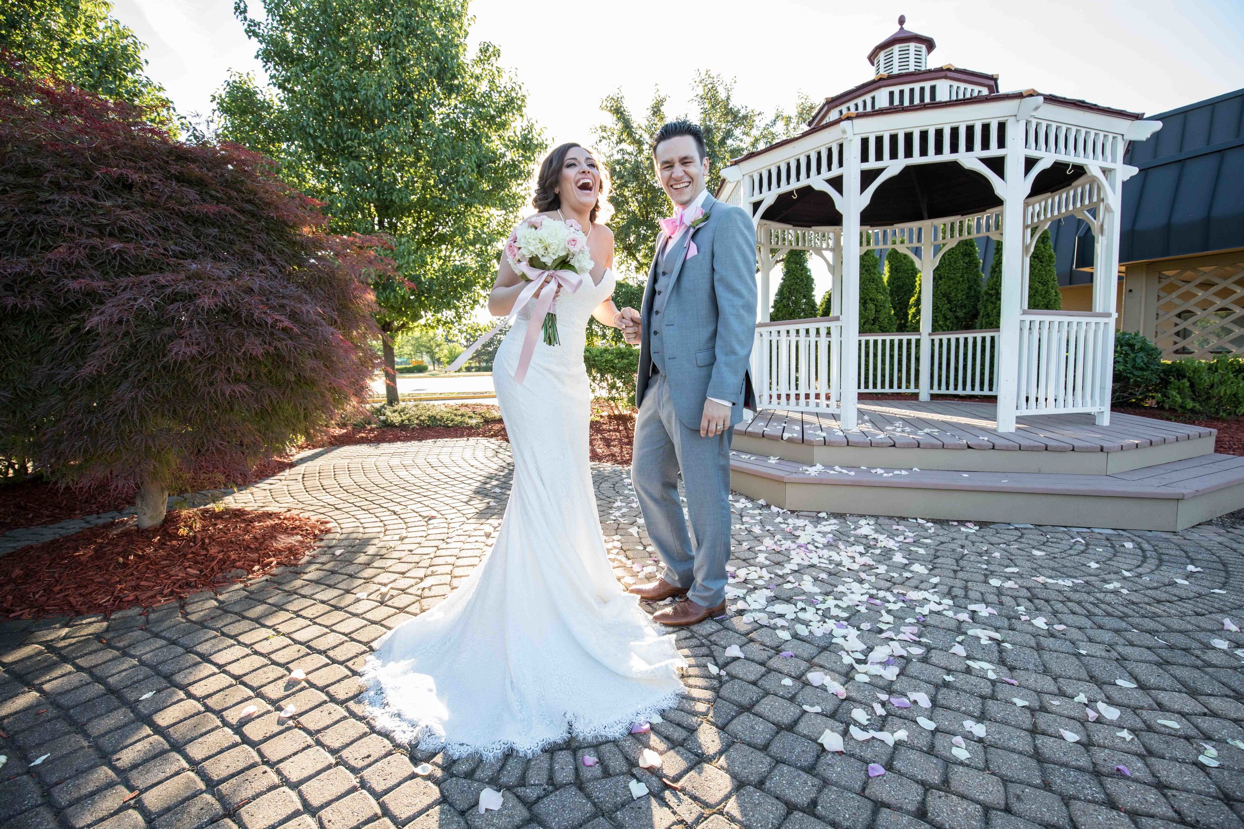  Bride and groom laughing during sunset portraits in front of gazebo 