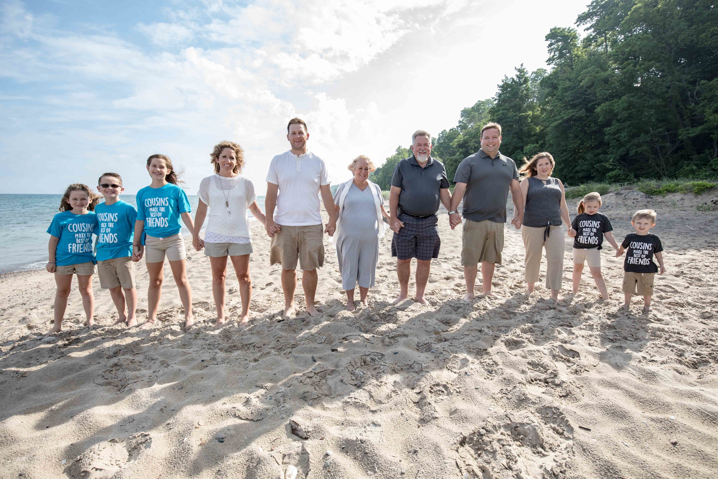  Large family lined up on a sunny beach 